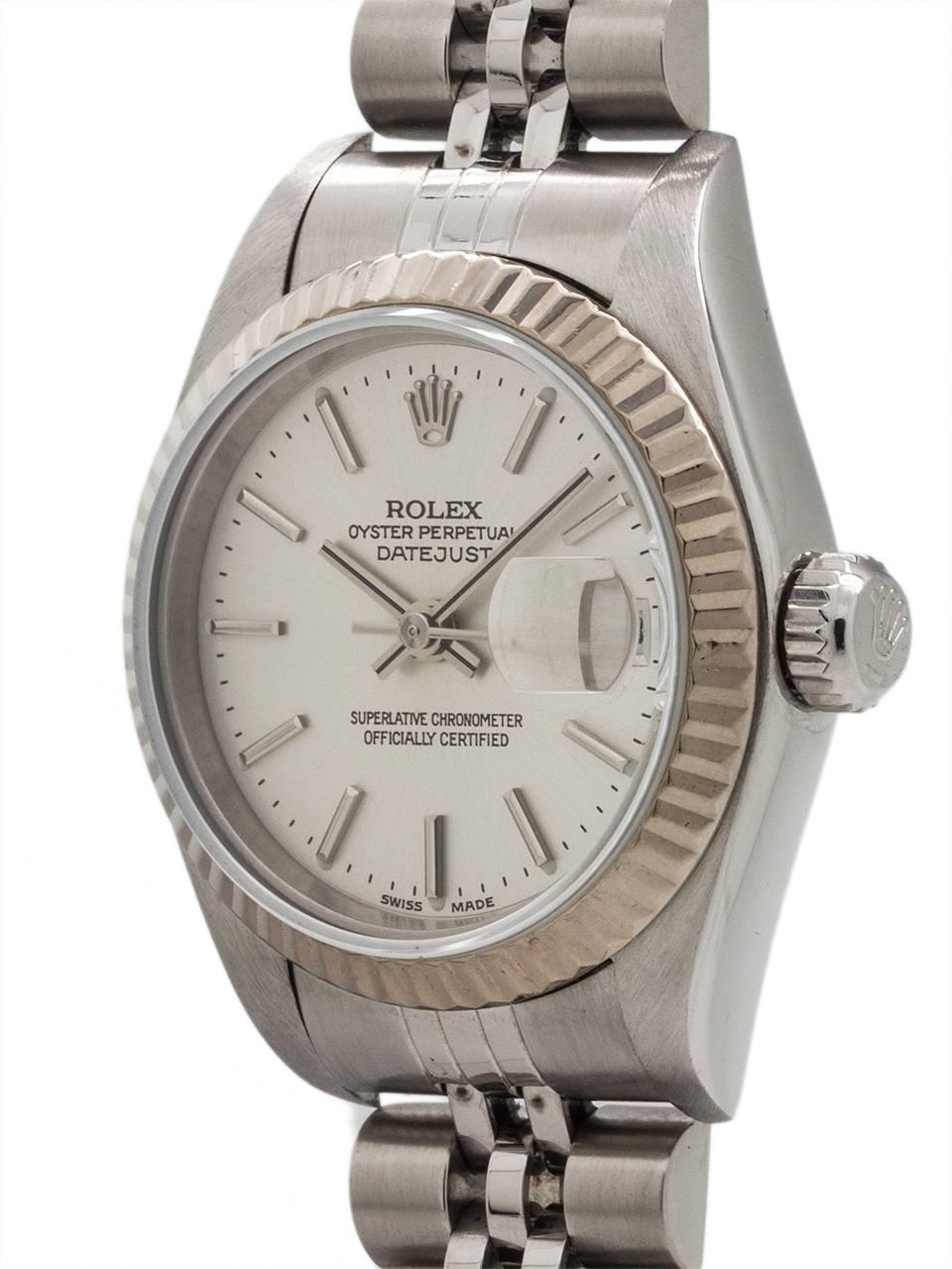 
Lady Rolex Datejust ref 79174 stainless steel 26mm diameter case with 18K WG fluted bezel, sapphire crystal, and original silver stick dial, circa 2003. Powered by self winding movement with sweep seconds and quick set date. With Rolex D link