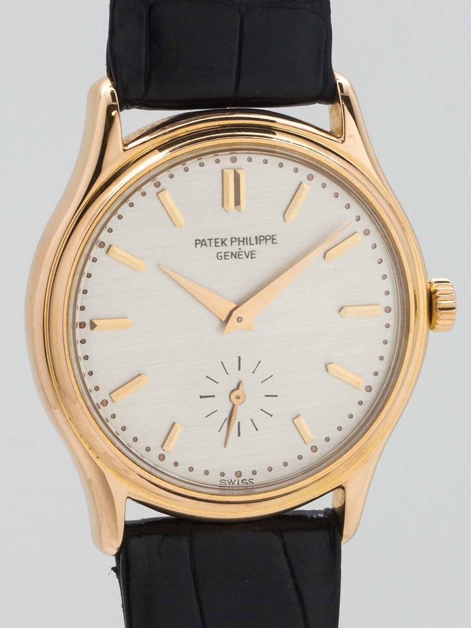 Patek Philippe 18K Pink Gold dress model ref # 3923 circa 1990’s. 32 X 38mm snap back case with original silver satin dial with applied pink gold indexes and tapered rose gold sword hands. Powered by 18 jewel manual wind movement with subsidiary