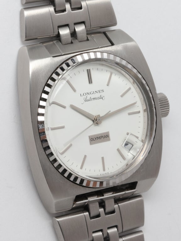 Rare and unique Longines Olympian. A sqare stainless steel case with sharp edges and wide, fat, down turned lugs. Featuring a tapered stainless steel bracelet and signed Longines clasp. The white dial is incredibly clean and has applied SS stick
