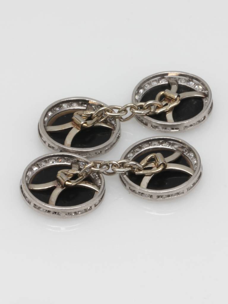 1900's French made platinum two sided round cufflinks with black onyx centers encircled by 25 old mine cut diamonds on each side. Estimated 1.50 carat total weight.

As a special offering for our 1stdibs customers, your purchase will arrive in one