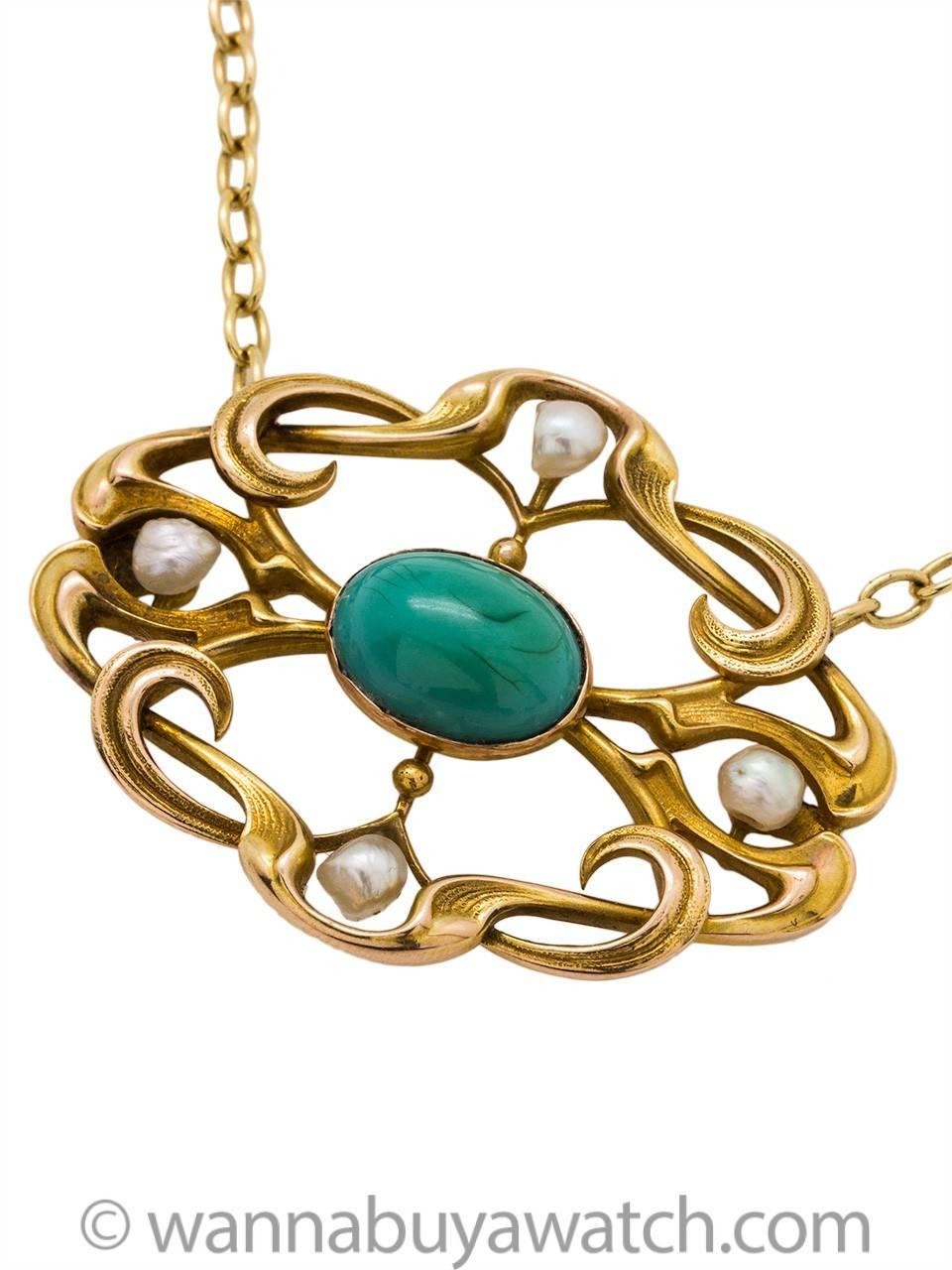 Art nouveau necklace crafted in a 14k yellow gold featuring 4 natural pearls approx 4mm each and bezel set. 9 x 12mm oval blue turquoise center set in curvaceous open frame work. 28 x 38mm on 18" oval link chain. Very lovely antique