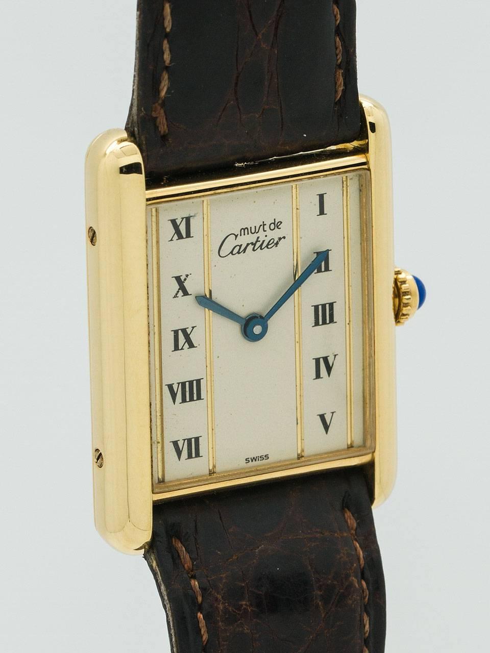 Cartier Man's Vermeil Tank Louis Must de Cartier, circa 1990s. Vermeil, 20 microns gold over silver, 23.5 X 31mm case secured by 4 case back and 4 side screws. Unusual dial configuration with 2 columns of Roman figures bordered by gold stripes with