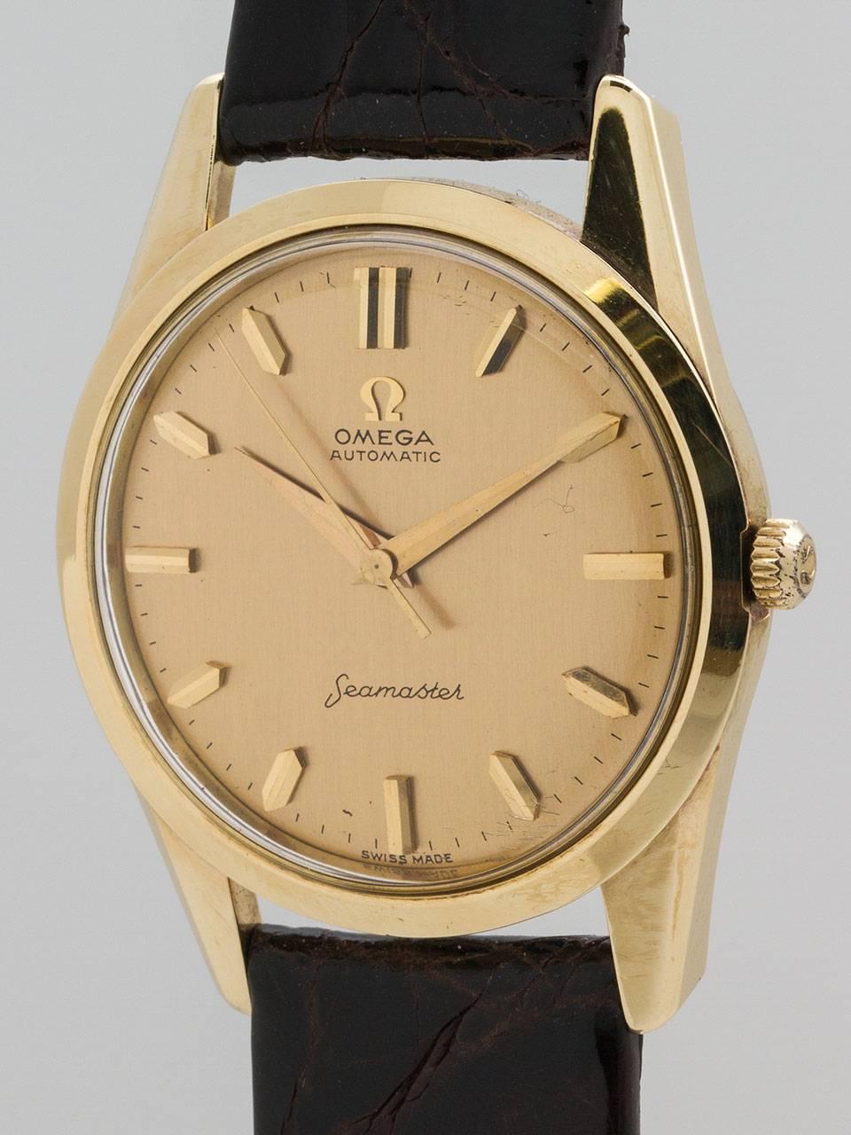 Omega 14K Yellow Gold Seamaster Automatic ref 14700 SC, serial #17 million circa 1960. Case measuring 35 x 40mm, screw down case back with deeply die struck high relief Seamonster logo. Pristine condition original sold gold dial with mirror gold