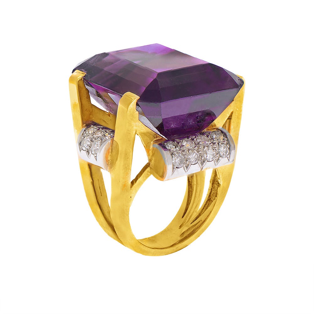 A very large central amethyst supported by an 18 karat gold split shank and accented with scrolling pavé-set diamond shoulders, circa 1940.

Ring Size - I 1/2