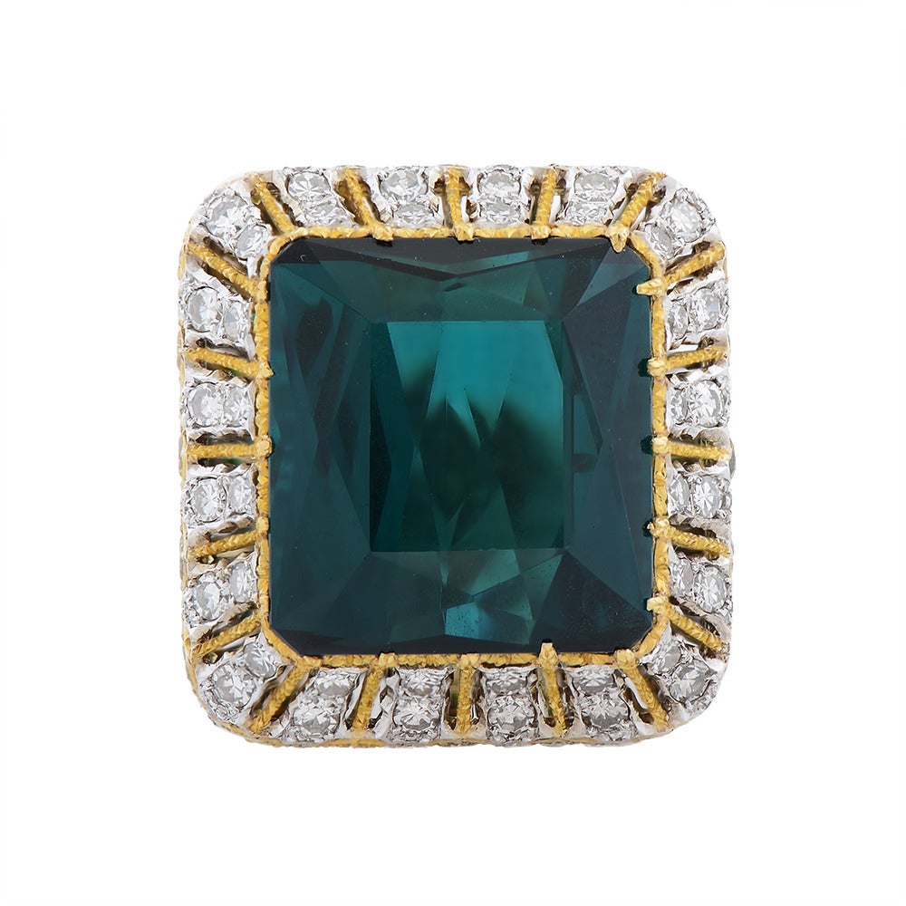 An Intricate Two-colour gold Tourmaline Fancy Yellow & Near Colourless Diamond Cocktail Ring, by Buccellati, Italian, circa 1980, claw-set at the centre with a rectangular mixed-cut stone estimated to weigh 15cts, the fine openwork crown, gallery &