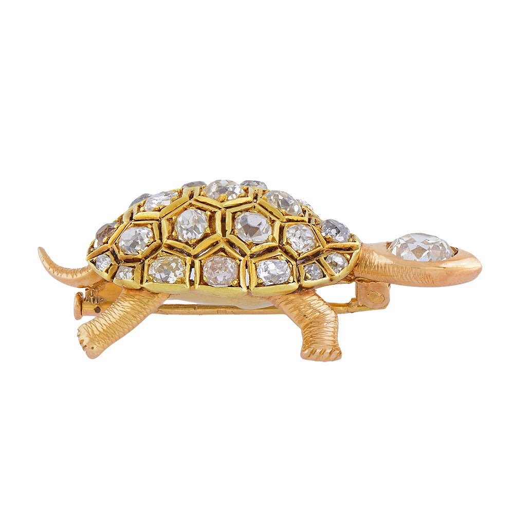 A French Gold & Diamond Turtle Brooch, the openwork yellow gold shell, collet-set throughout with antique cushion-shaped diamonds, the head, feet & in rose gold, the former similarly set with a stone estimated to weigh 1.2cts, bearing French import