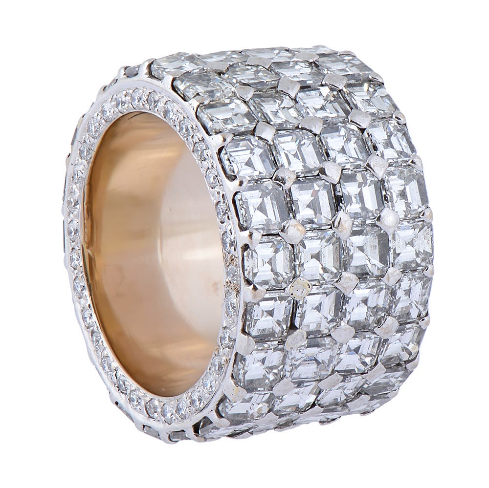 A diamond eternity ring composed of four rows of Asscher-cut diamonds of H colour and VS clarity, totalling approximately 15cts, set in white gold, the rims pavé-set with approx. 0.6cts of small, round diamonds. Ring size K½ (UK) or 5.5 (US).