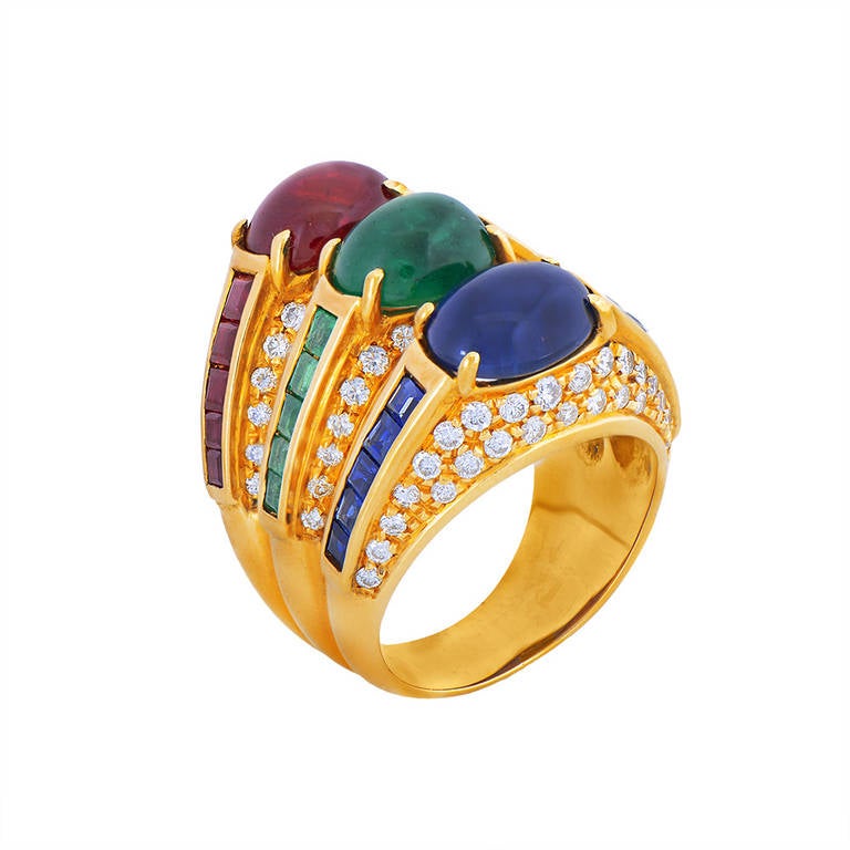 A pave diamond set three tier ring composed of 18K gold, each tier holding a central cabochon gem with a matching row of calibrated stones on either shoulder. 

Ring Size - K