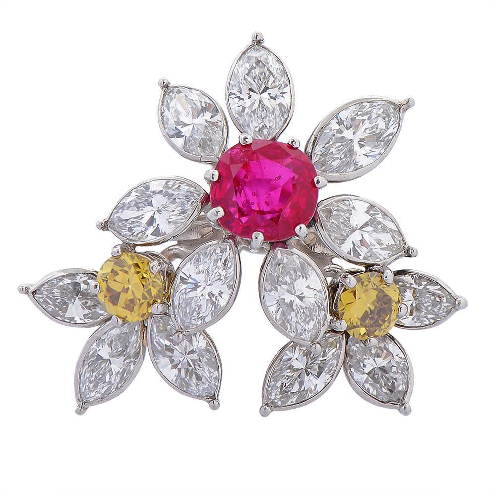 A Burmese ruby and fancy yellow and white diamond flower ring, Monture Cartier, designed as three flowers, the largest centred on a 1.84ct Burmese ruby and overlapping two smaller flowers with fancy yellow diamond centres, all with marquise-cut,