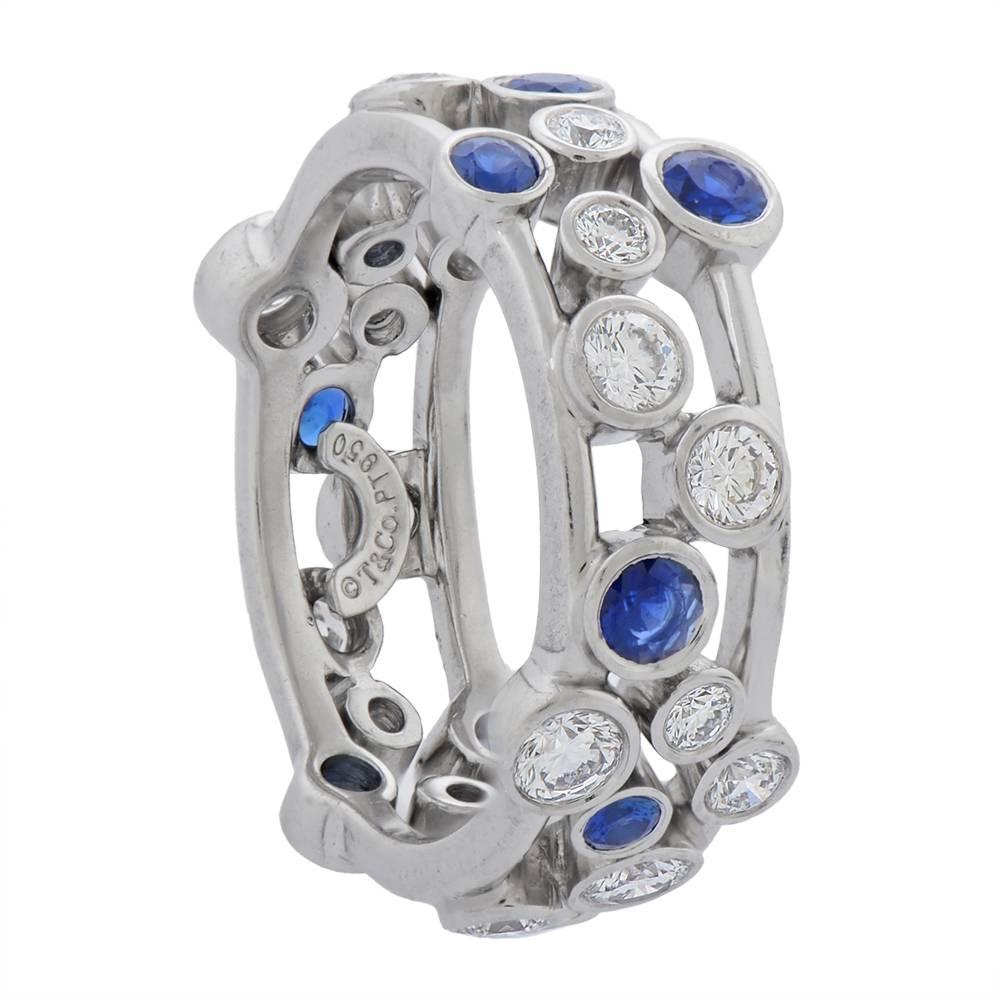 A platinum, sapphire and diamond “Bubbles” ring by Tiffany & Co, of their signature bubble motif, composed of a medley of bezel-set round brilliant-cut diamonds, totalling approximately 1.65cts, and round-cut sapphires encircling two adjoining