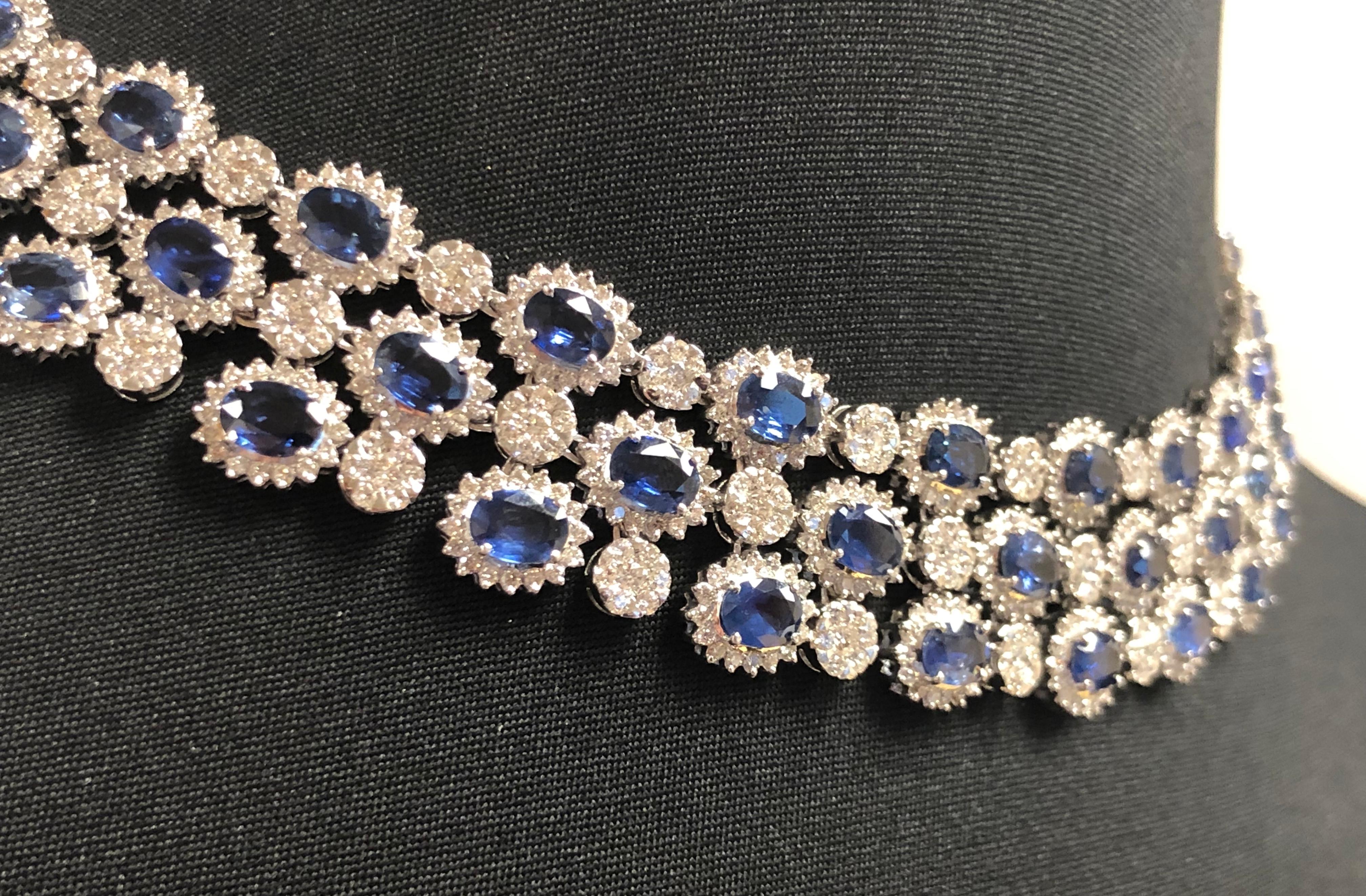 This one of a kind necklace features an astonishing 78 blue oval sapphires (for a total of 70.07 carats) , each with a white diamond halo and separated by a circle pave diamond design. This necklace is secured with a hidden clasp and safety lock,