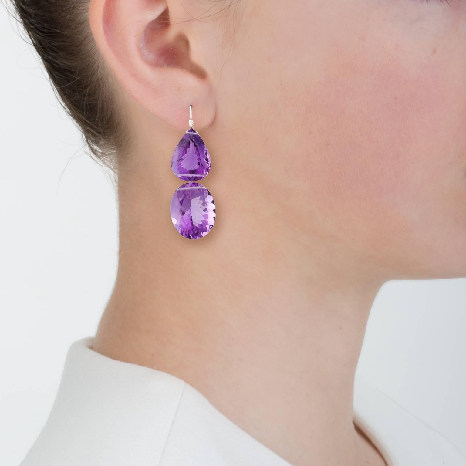 Large amethysts make a bold statement.  These double amethyst earrings of high quality have hints of red fire. The large stones make a bold earring that is appropriate for day or night.

Brazilian amethyst - 118 cts
Platinum wire
18k white gold