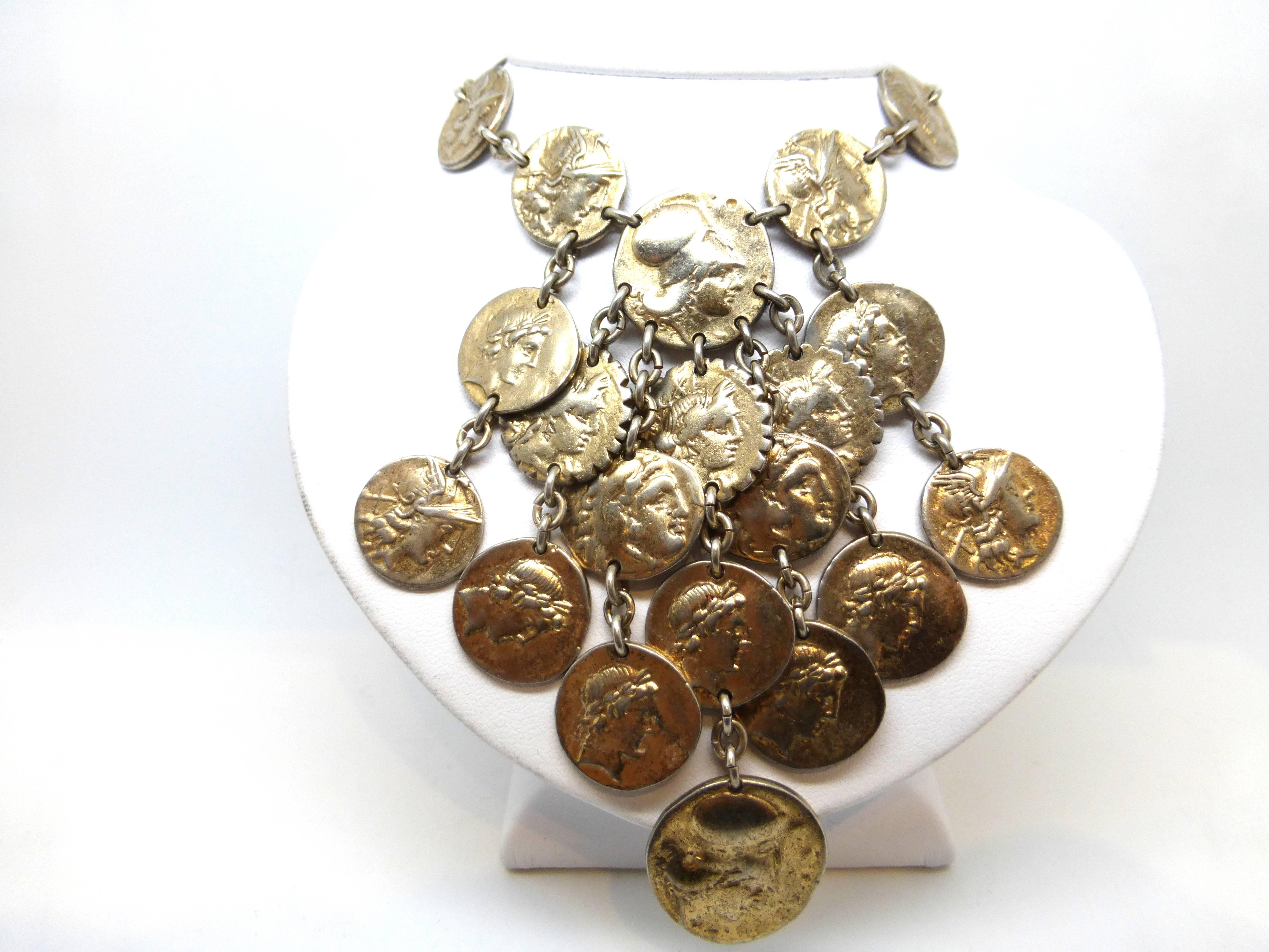 Nettie Rosenstein, Mid Century, sterling silver - gilt, Classical Greek Revival necklace, decorated with faux Greek Drachma coins depicting a Greek soldier's head on one side and a chariot, horse and rider on the other, Ca. 1940's-1950's. A little