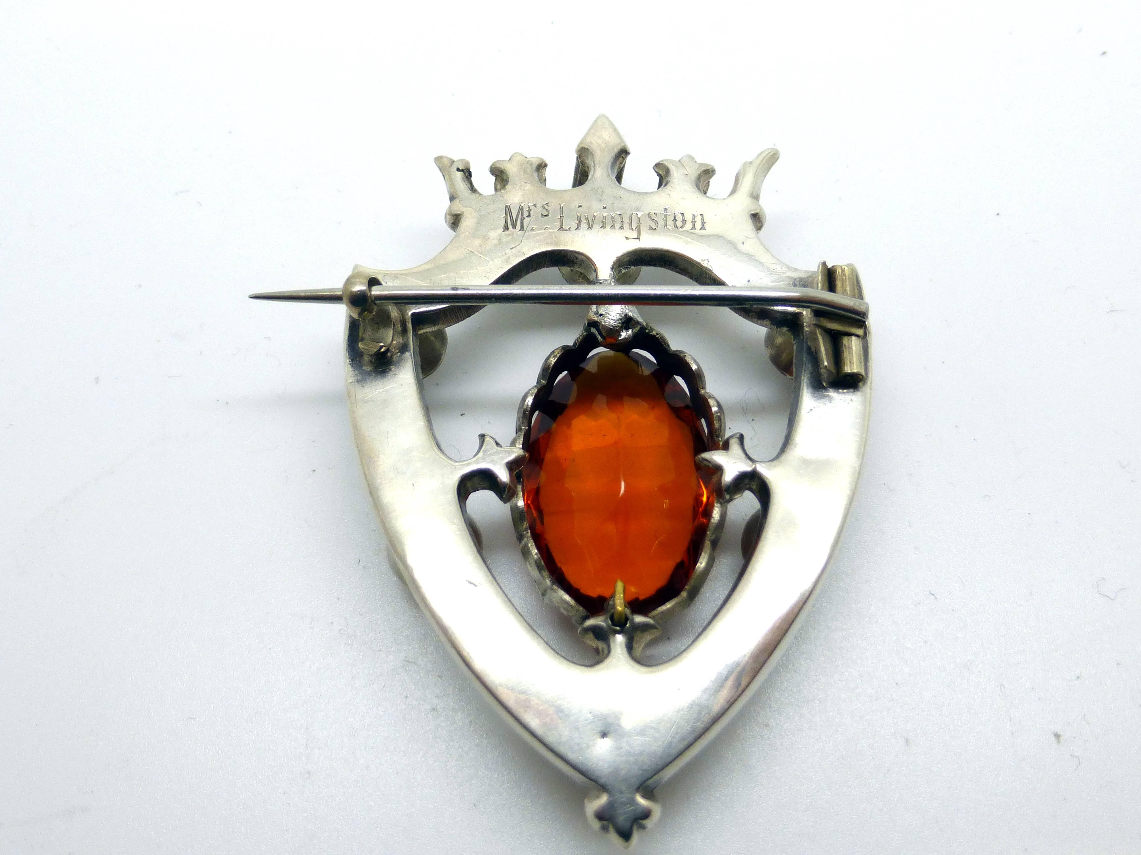Lovely, large, Victorian, Scottish, sterling silver shield-form brooch decorated with stones and having a central cairngorm, Scotland, Ca. 1880's. Sterling mount is lightly etched and is topped by a crown. @2 1/4