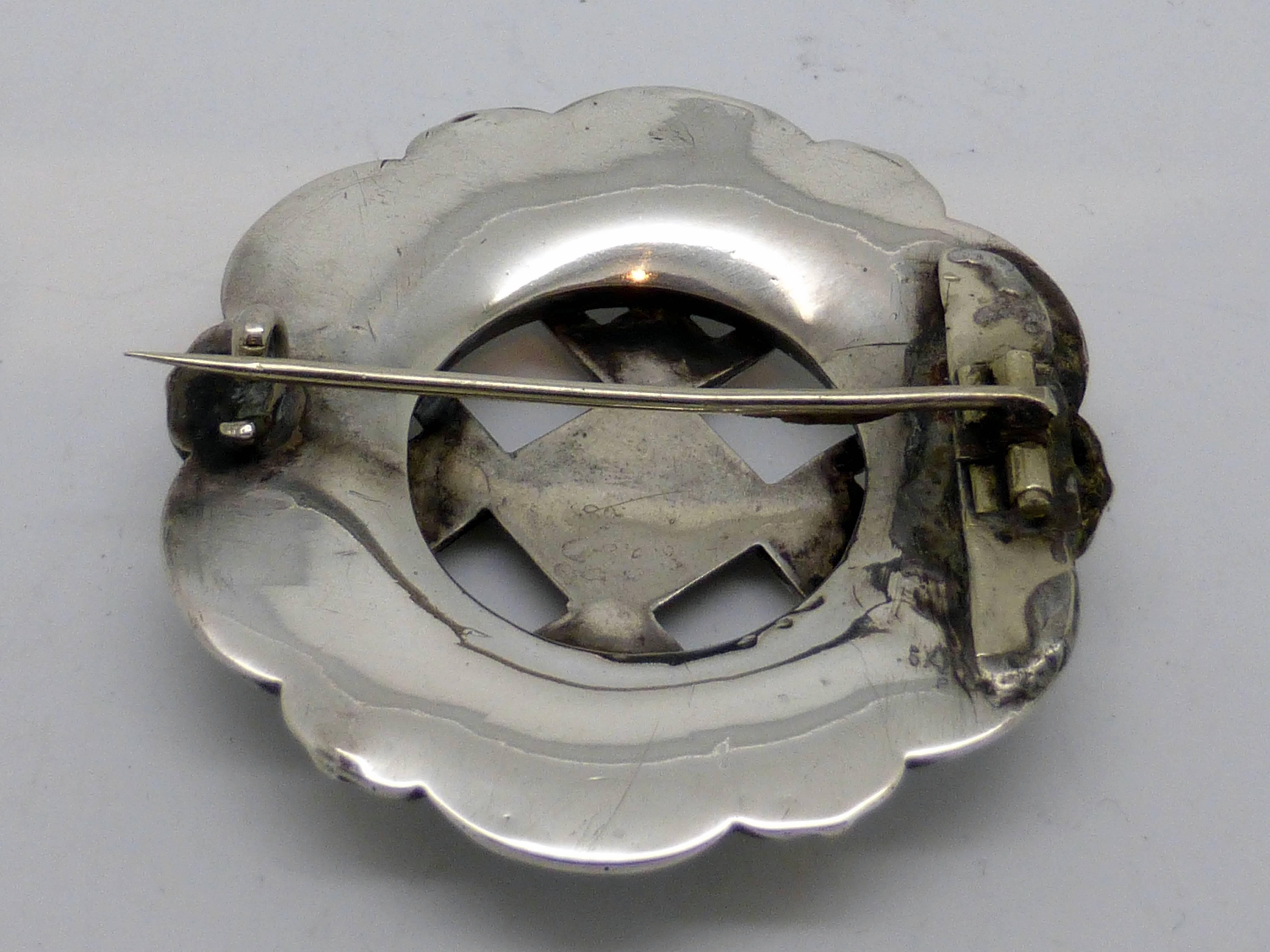 Victorian, sterling silver - mounted (unmarked but tested) Scottish agate brooch, Scotland, Ca. 1880's. Openings in center of brooch allow fabric to show through. Lovely etched work on sterling silver mount. @1 3/4