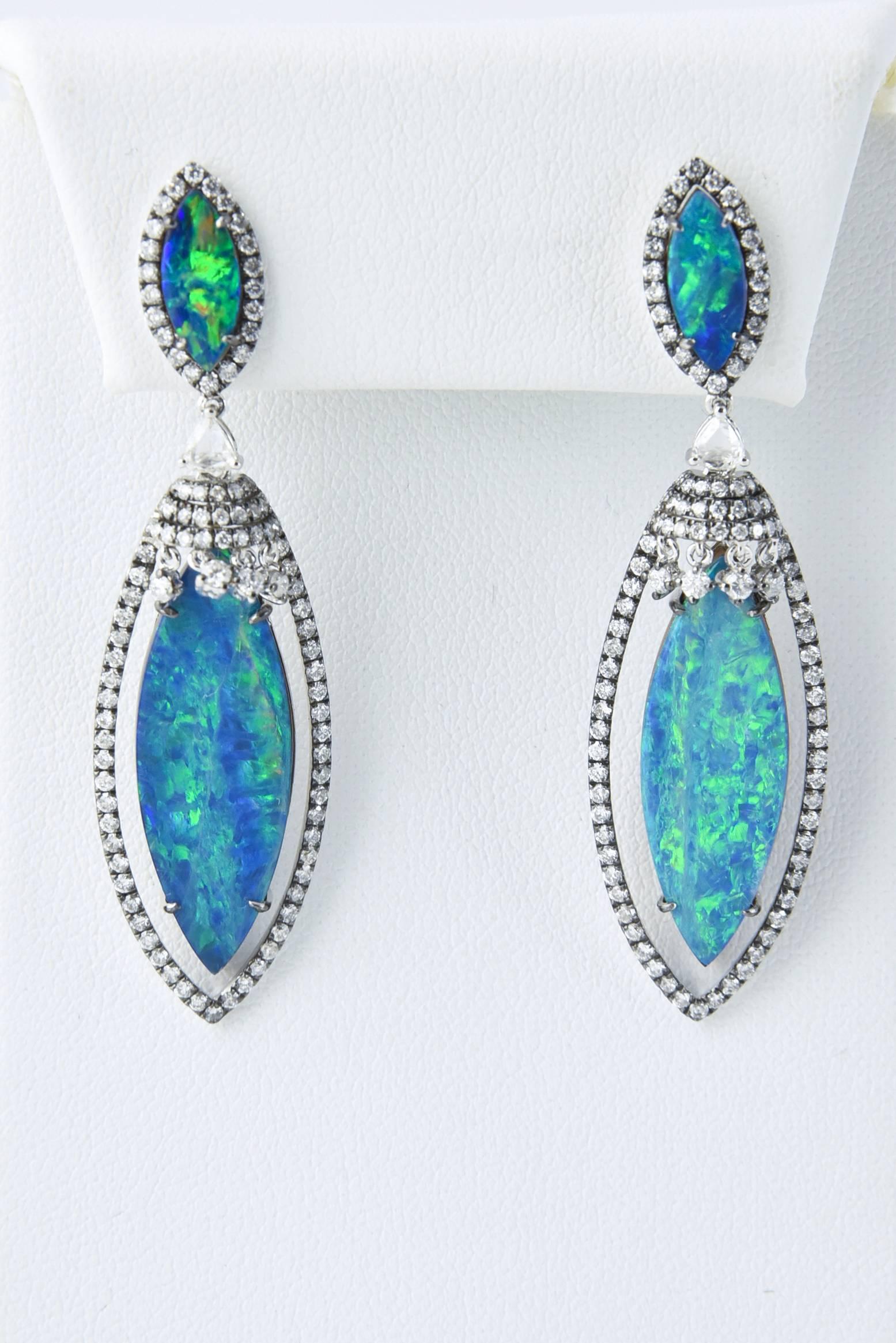 Stunning Well Matched Opal Doublet Earrings mounted in 18 karat white gold accented with 1.82 carats of diamonds.