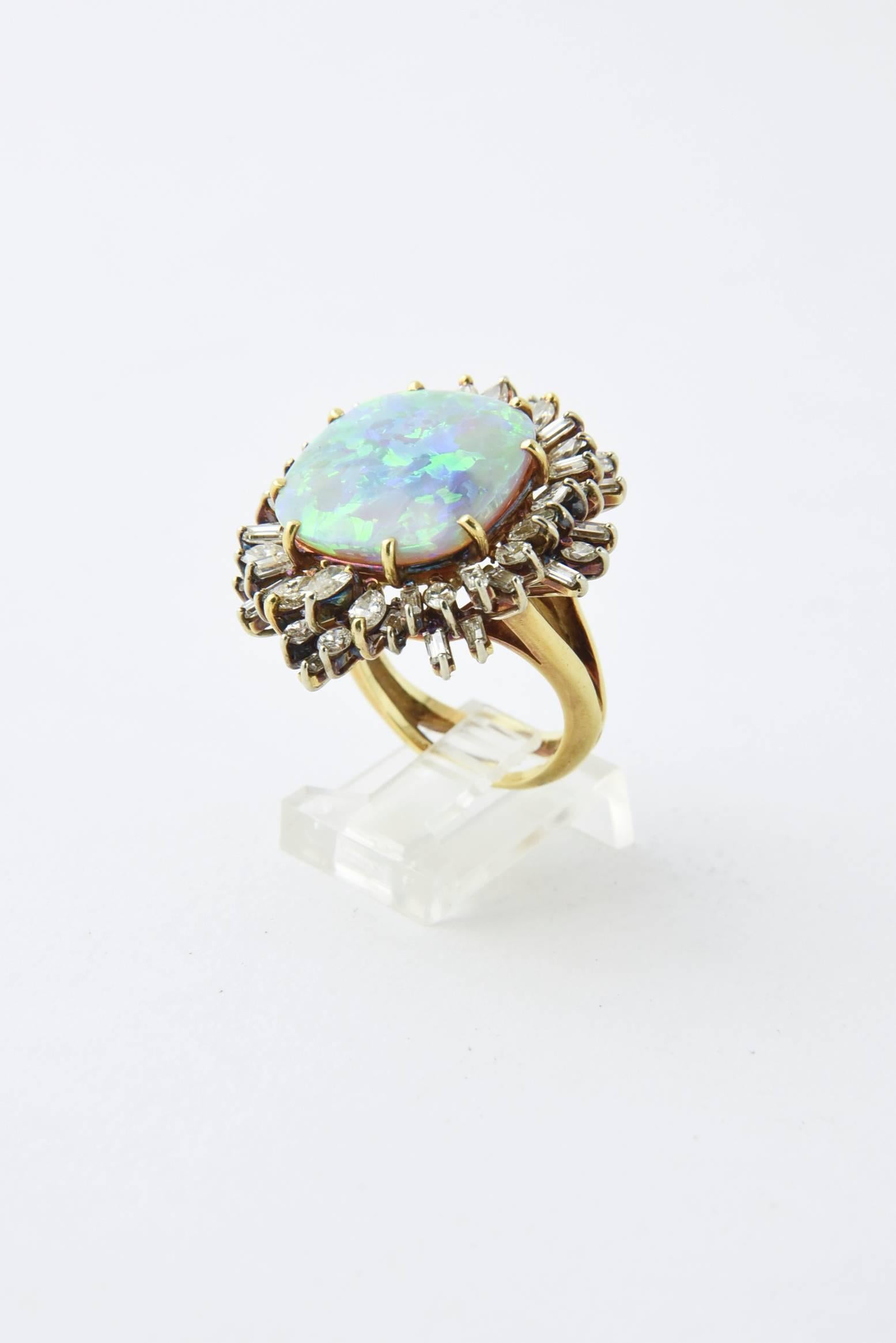 Fine opal ring featuring a 12c approximate weight Australian square shaped gray crystal opal with green, blue and orangish red play of color mounted in an 18k gold mounting full of baguette, marquise and pear shaped diamonds. 

US size 7