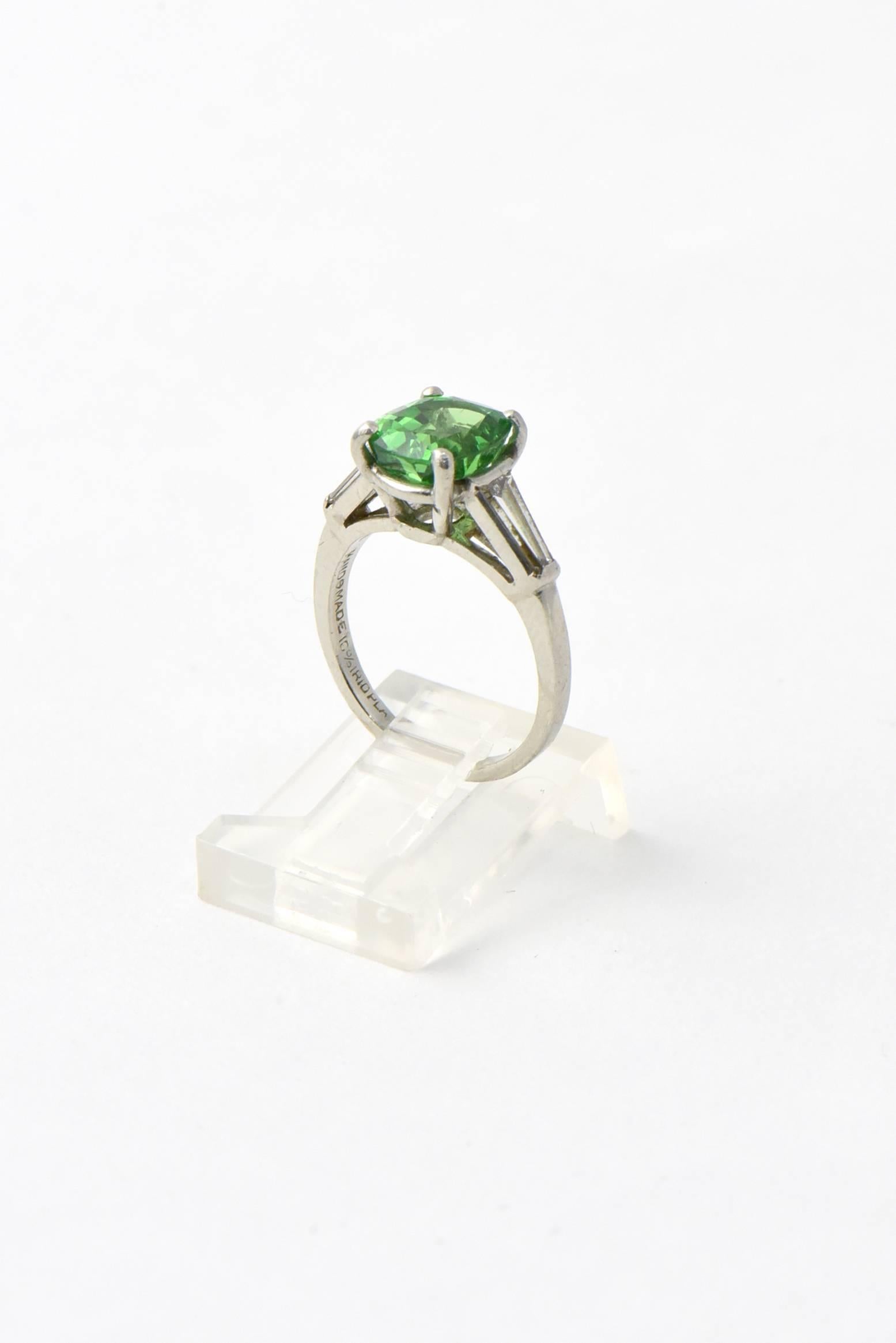 Stunning GIA certed natural Tsavorite Garnet mounted in a simple tapered baguette diamond and platinum mounting.  The 2.78 carat tsavorite  2.78 is an gorgeous green transparent color.  

US size 4.5.  It can be sized.