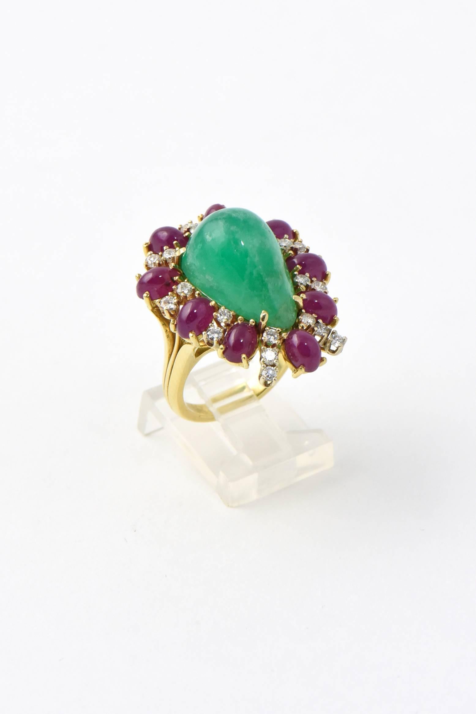 Impressive custom made ring featuring a large cabochon pear shaped emerald surrounded by prong set cabochon rubies and diamonds.  This stunning statement ring is made of 18k yellow gold.

US size 7 - it can be sized.

This ring as well as a