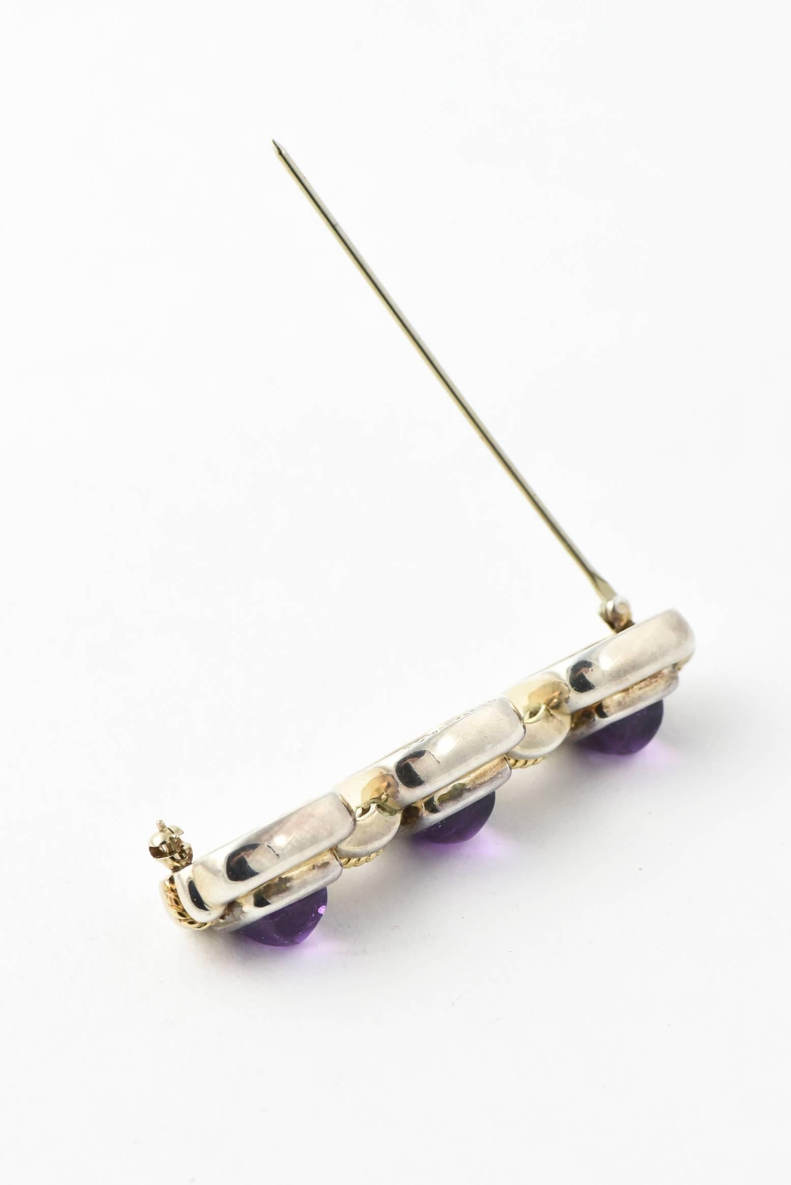 20th Century Tiffany & Co. sterling silver brooch with 2 dimensional square links with bezel set sugarloaf amethyst centers held together by sterling bridges with  18k gold rope accents down centers.

Marked Tiffany & Co. 925 750