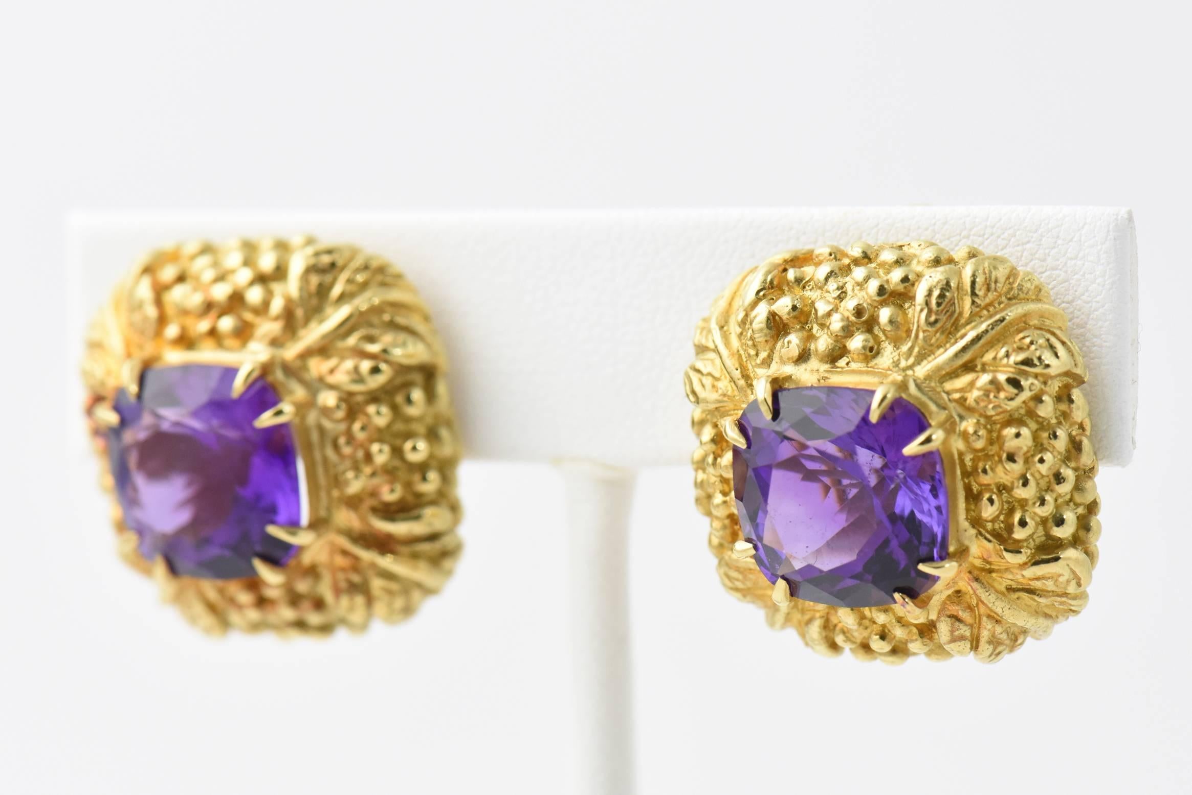 Highly stylized square textured earrings with 3d gold work that includes leaf corners centrally set in each is a square shaped amethyst.  The piece is 18k gold.

Clip backs - no post.
 