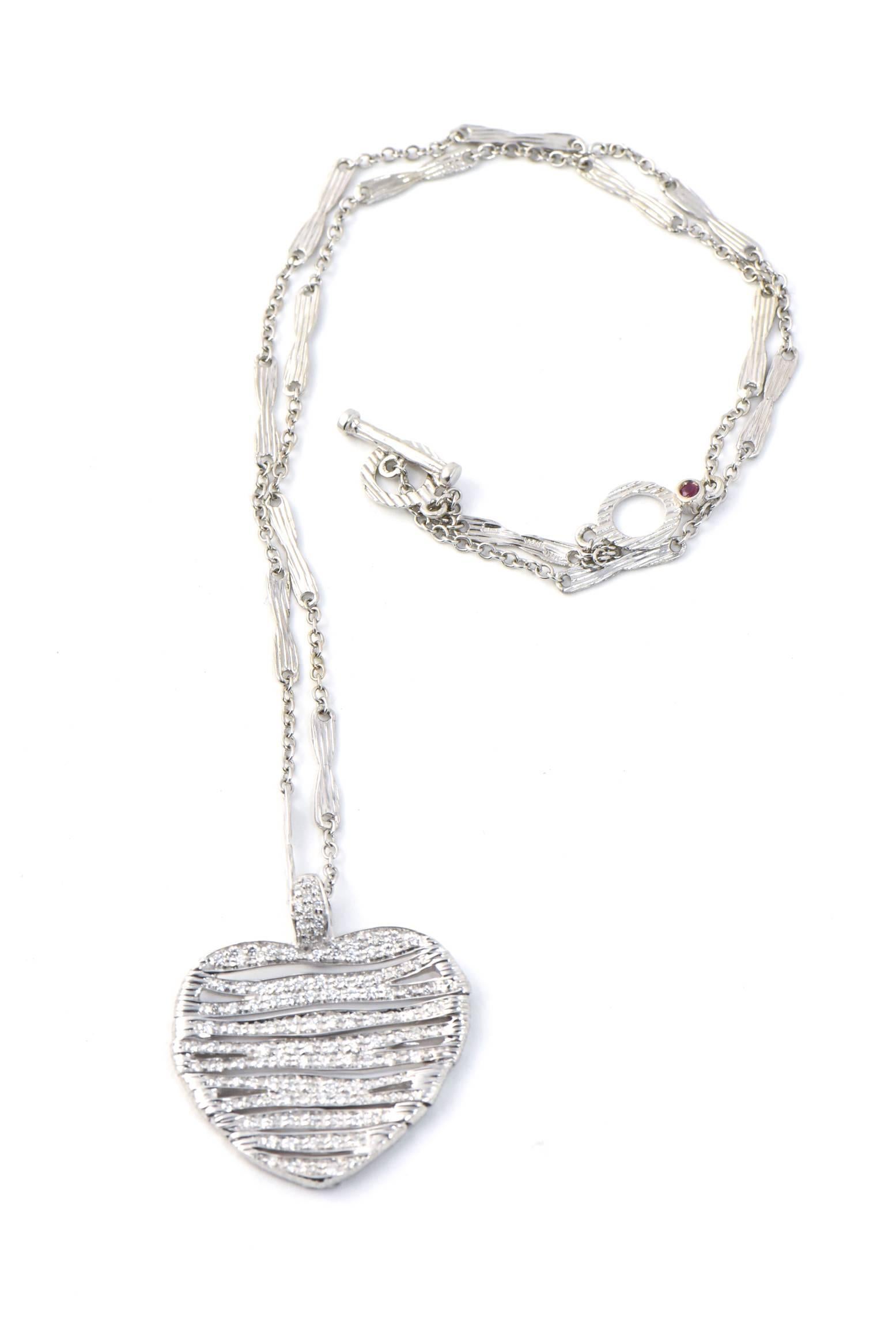 Roberto Coin Diamond Heart Pendant from Elephant (Elefantino) Collection
consisting of an 18k white gold heart pendant which is a textured, slightly oval articulated pendant, set throughout with round brilliant cut diamonds. The pendant is