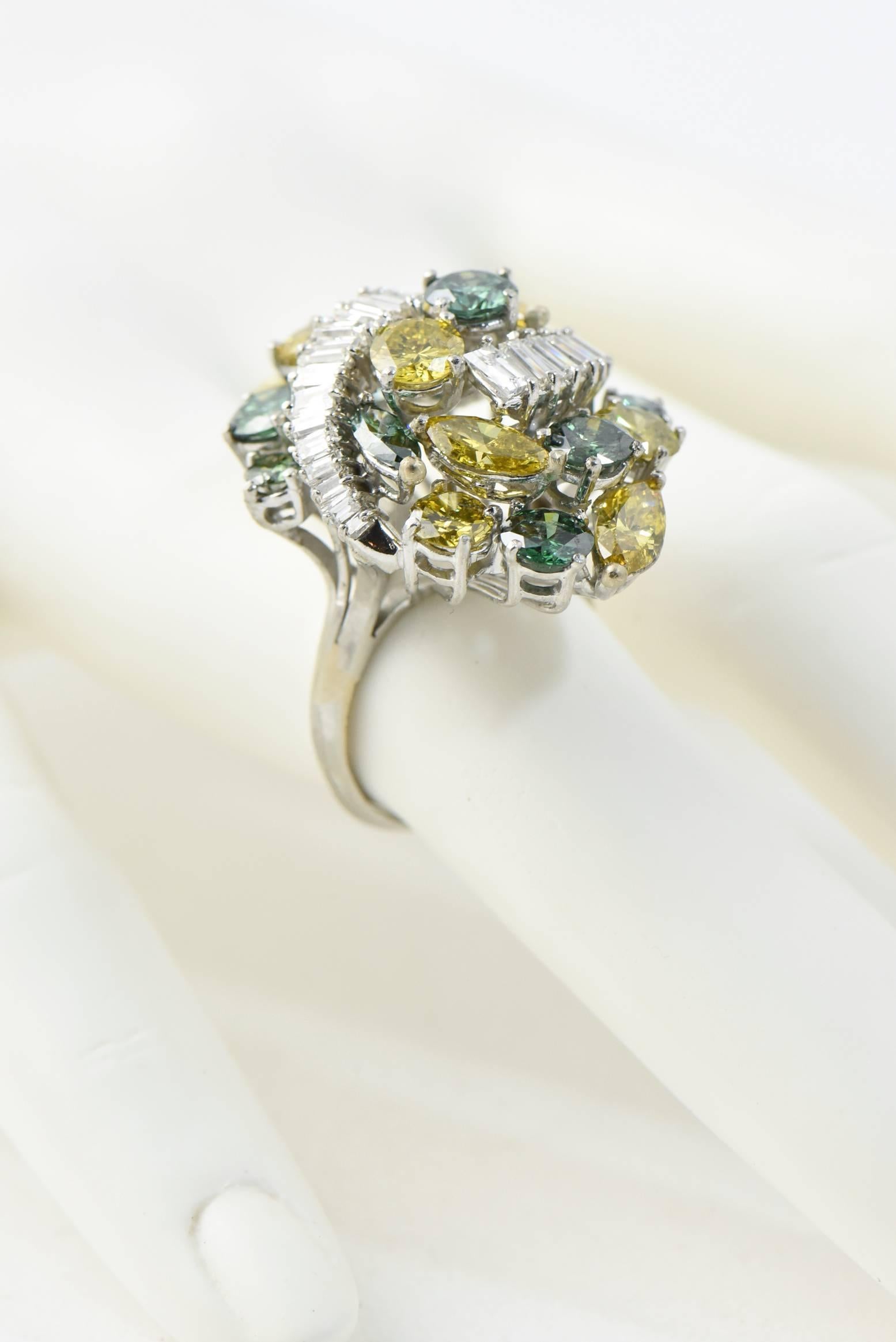 Impressive treated and near colorless diamond cocktail ring set with a cluster of circular and marquis-cut treated yellow and green diamonds accented by graduated baguette - cut near colorless diamond arches mounted in platinum.  The approximate