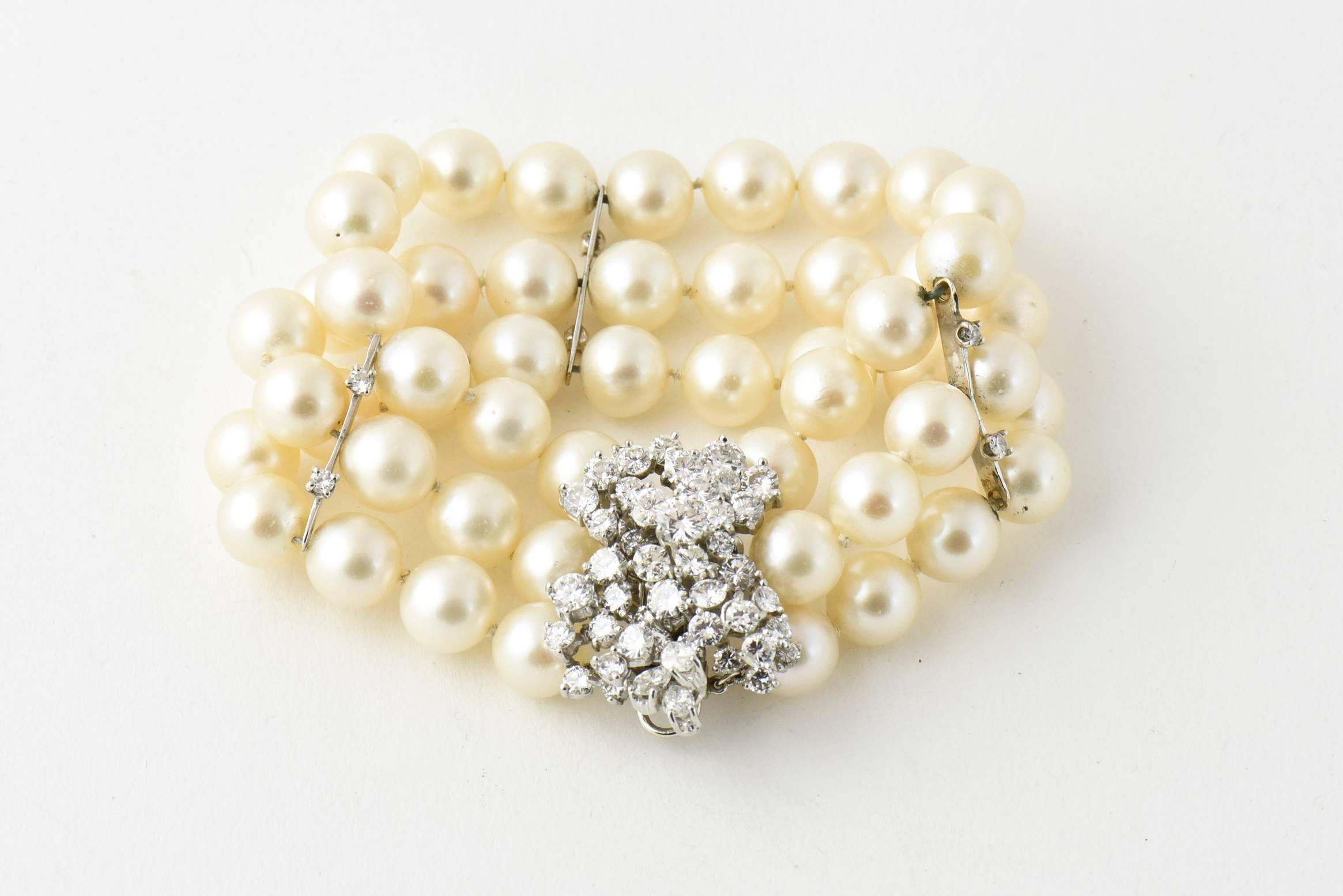 Perfect piece to wear with a gown or a suit, this impressive cultured pearl bracelet has three strand of pearls ranging from 8.9 mm to 9.10 mm.  The push button clasp has approximately 4.5 carats in fine white VS to SI stones  The diamonds are