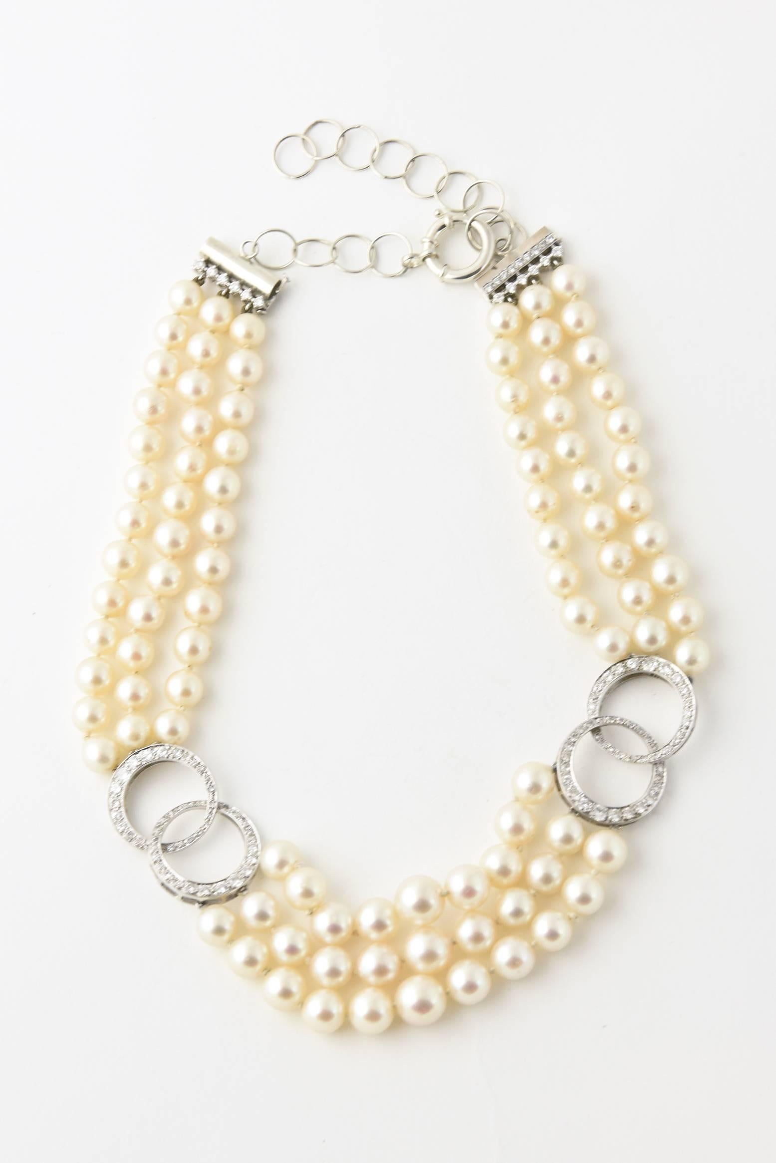 graduated 8 - 10mm Cultured pearls with layered diamond circle accents. 3 carats of diamonds.  The necklace is 14k white gold.  The client added a sterling extender to make it longer.  We can have it professionally returned to original form if the