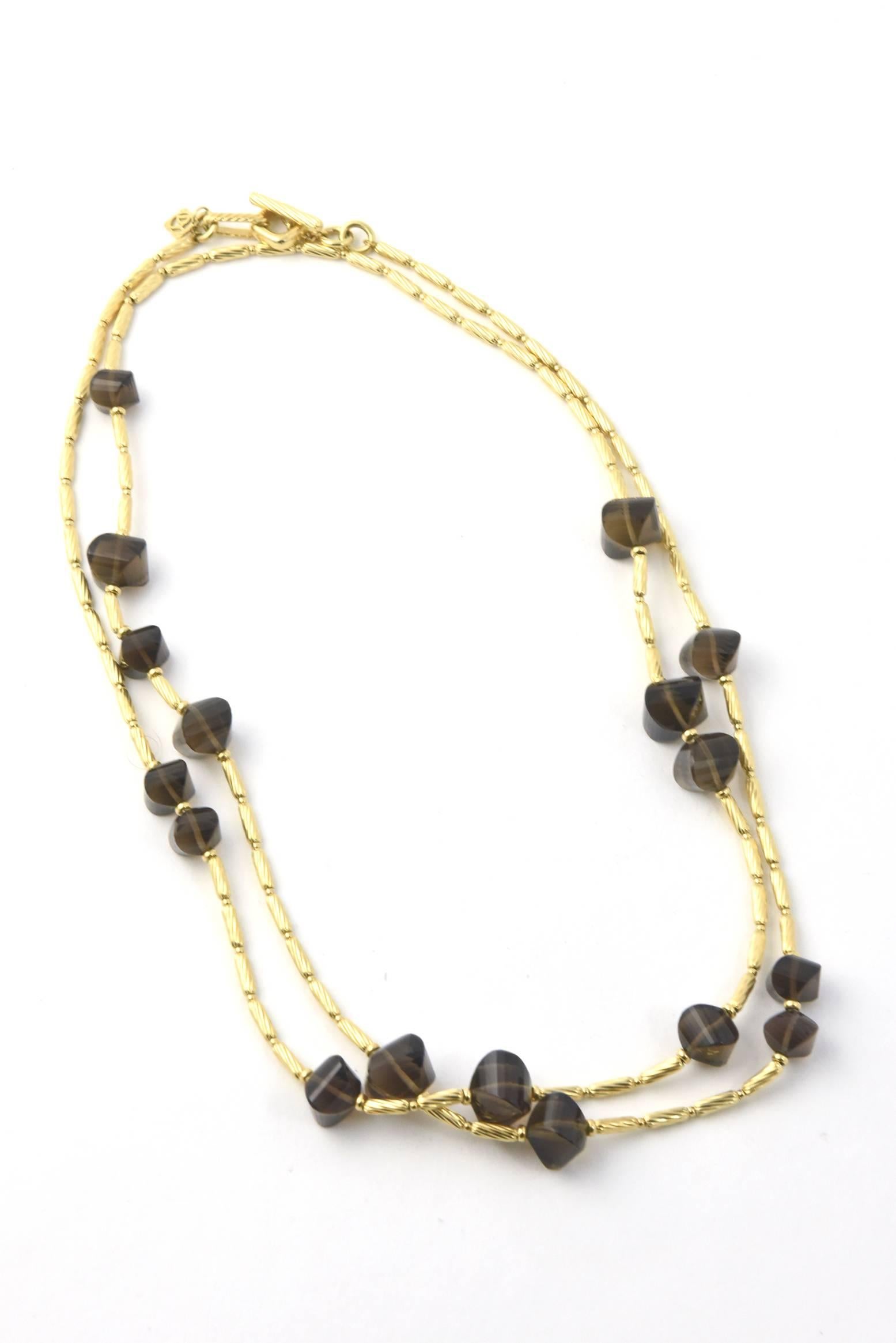 David Yurman 18k Yellow Gold twisted cable sculpted beads  & smoky quartz bead necklace. Toggle clasp. Necklace, 44''L. Beads, 16mm - 10mm in diameter. 

Marked: D.Y 750