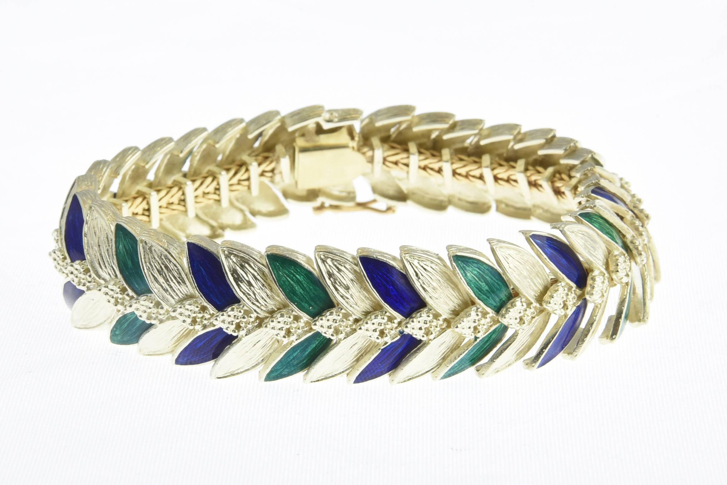 14K gold bracelet accented with etched gold and blue and green enameled leaves. Marked: 14K. 
