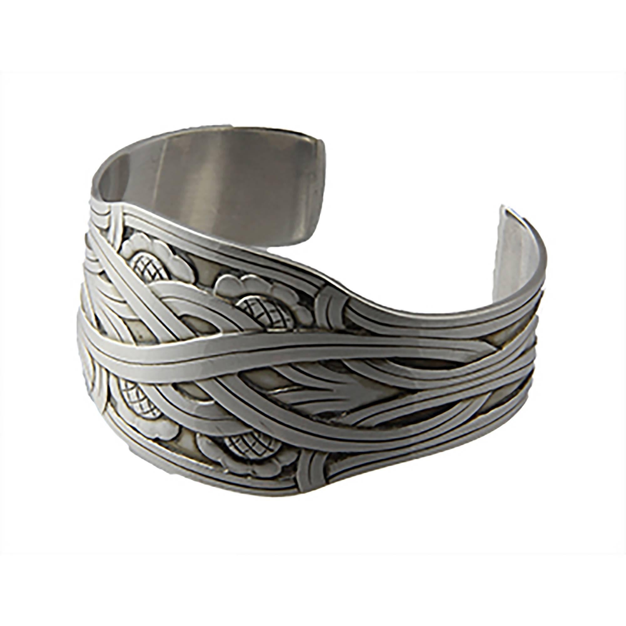 Sterling silver Georg Jensen cuff bracelet was designed in 1935 by Harald Nielsen. His designs are characterized by an emphasis on form and line, with a minimum of ornamentation. A similar example of the design can be found on p. 264 in the book,