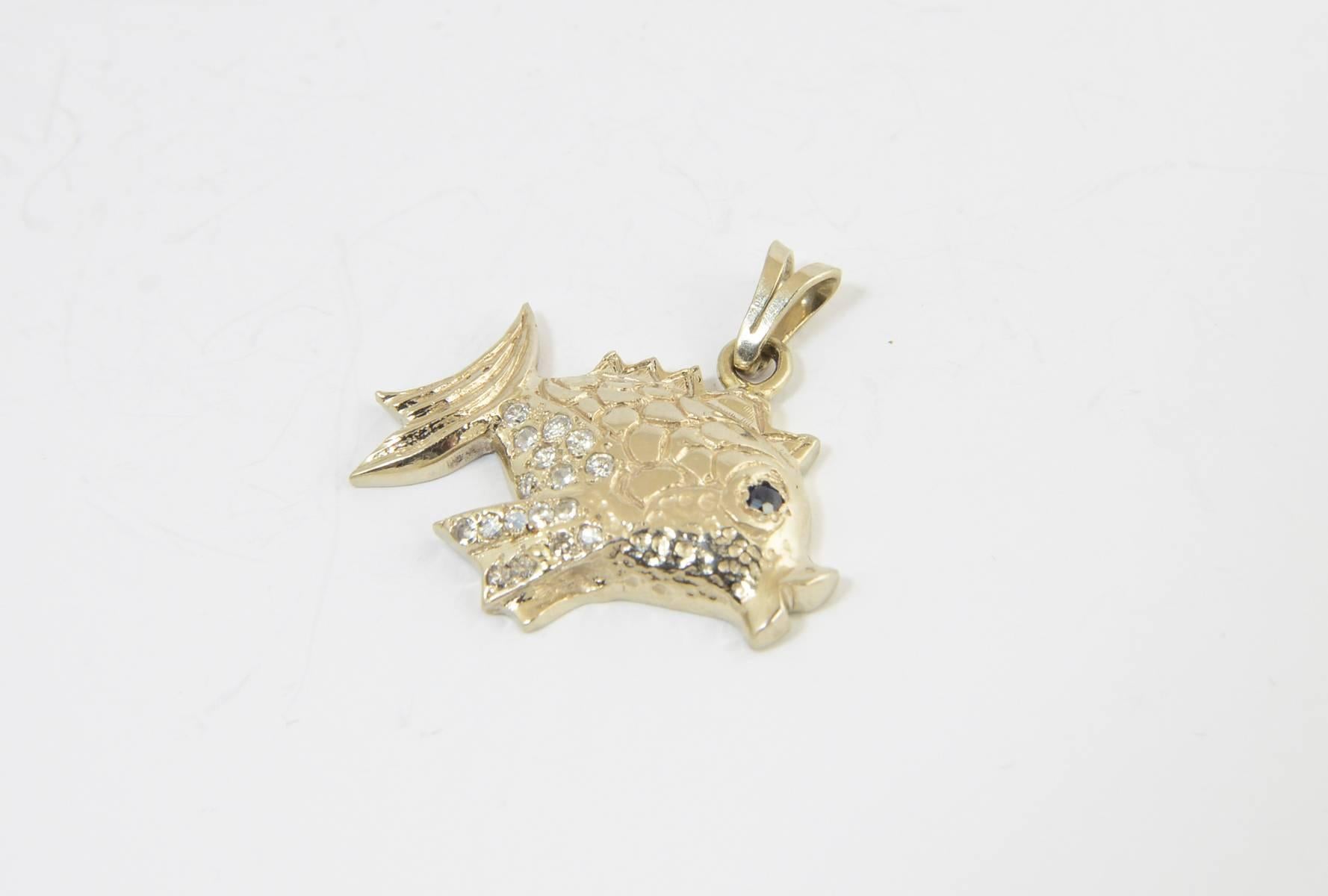 Pavé diamond fish pendant/charm made of 14K yellow gold.