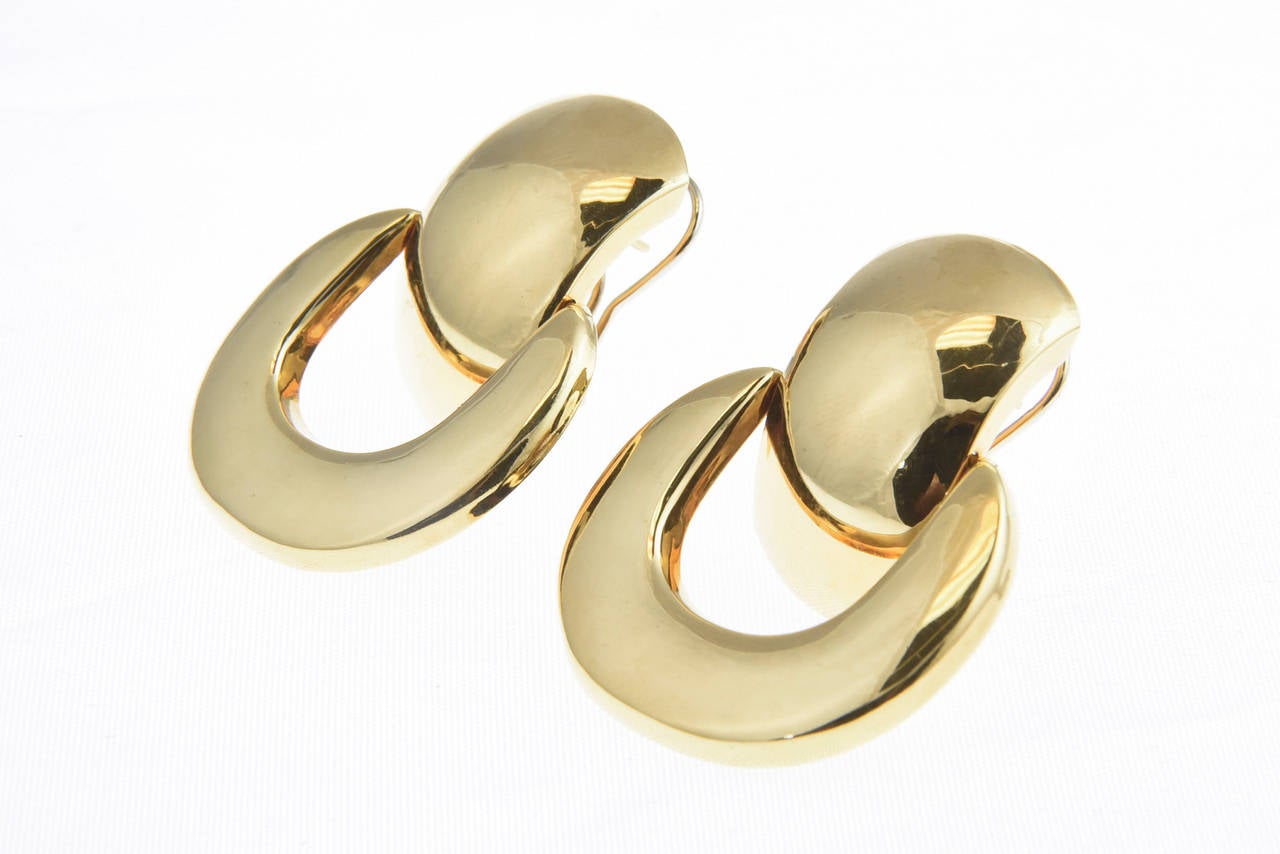 Large but not too heavy, these 18k yellow gold door knocker earrings have a post and clip so lay nicely.

Marked 18k