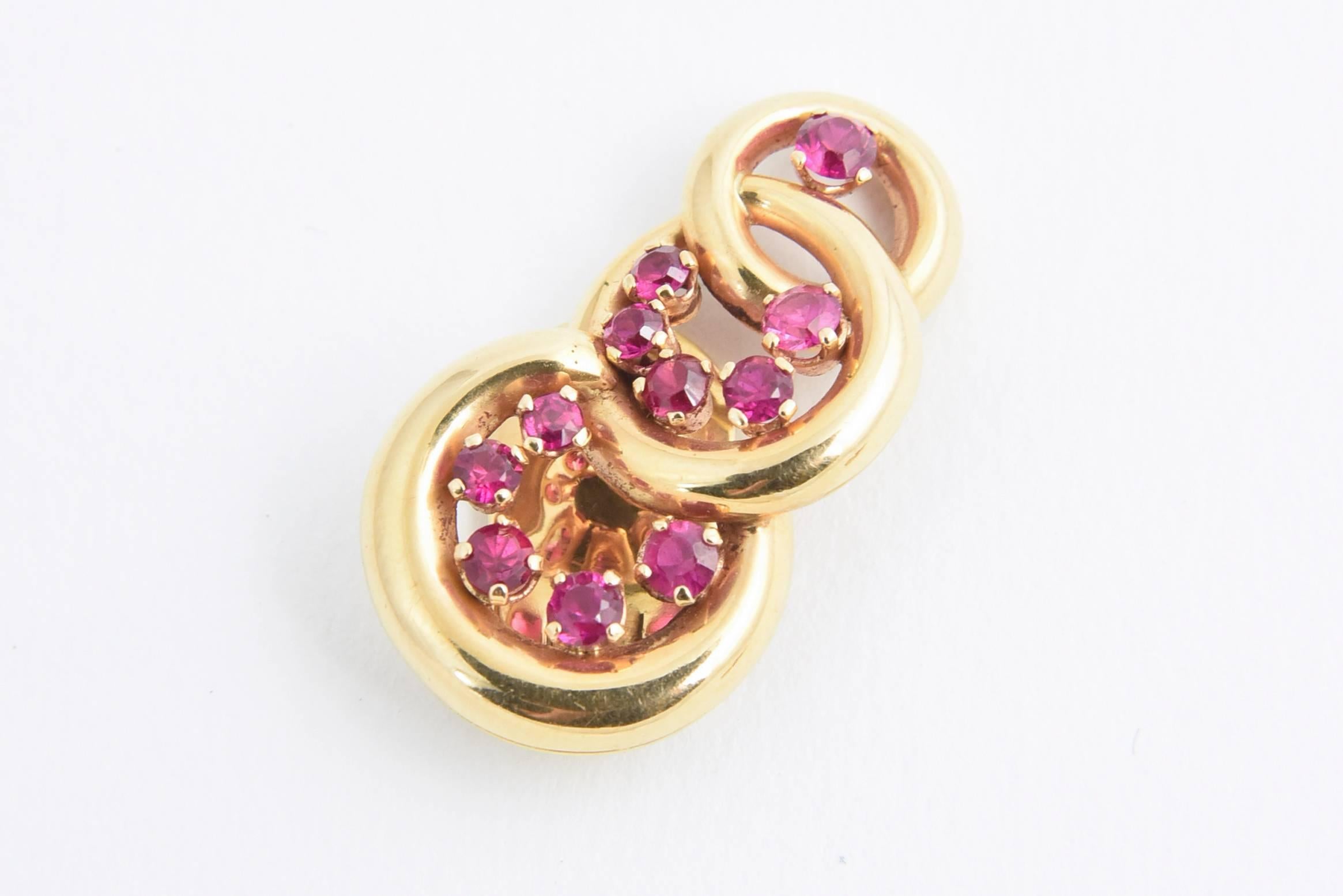 Retro graduating interlocking 18k yellow gold circles accented with synthetic rubies. 

These earrings have clip backs - no posts

In the early 19th century the synthetic ruby was created in a lab that was physically, chemically and visually the