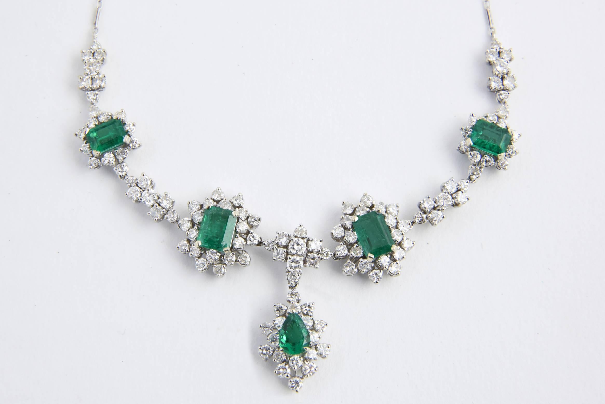 Glamorous 1950s emerald and diamond necklace featuring 5 brilliant Zambian Emeralds surrounded by approximately 5 carats of beautiful diamonds.  

The necklace was examined by GIA who identified the emerald as Zambian with type F1 enhancements. 