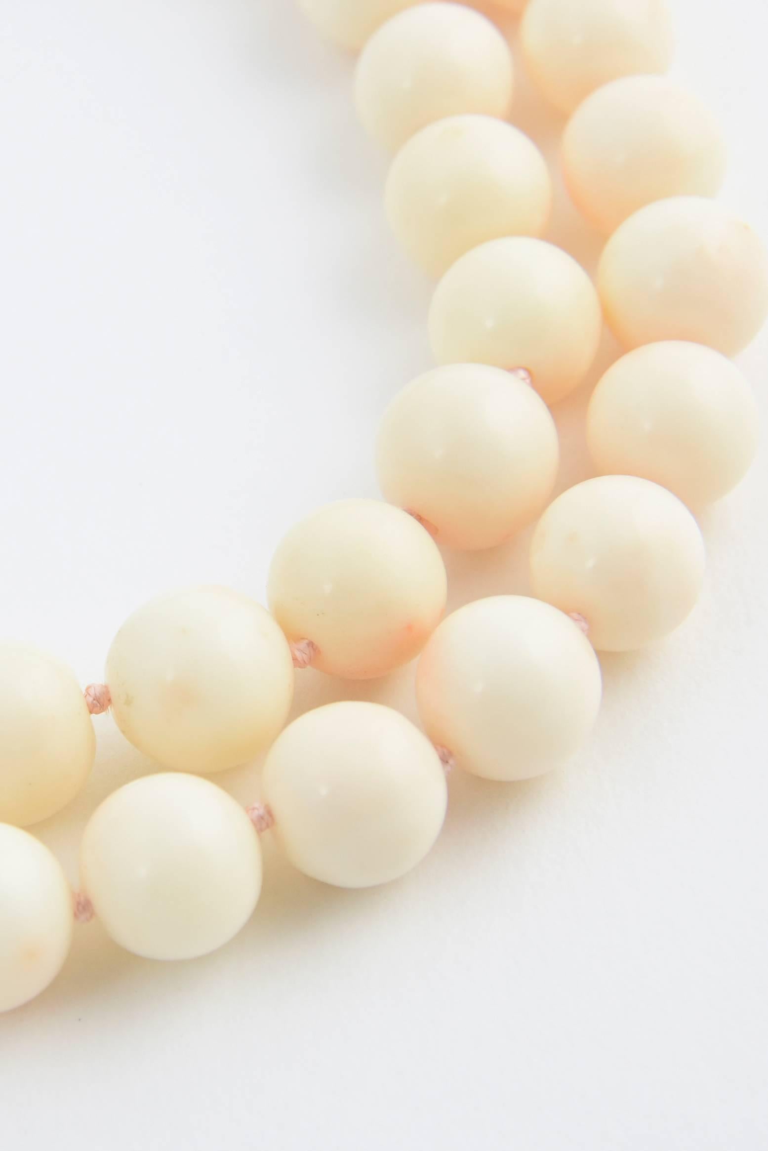 Beautiful 33 inch strand of 13mm - 14mm angel coral beads make up this necklace.  The coral is a lovely delicate pink shade with knots between each piece.  This necklace is made to be worn long, but if you want you can use a special pearl shortener