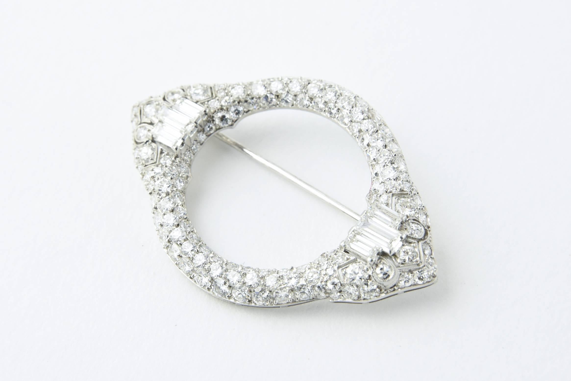Elegant Art Deco Platinum and Diamond Circle Brooch circa 1930s consisting of bead set European cut, round brilliant cut and baguette cut diamonds for approximate 4.25 carats total weight. Great style and workmanship can be seen throughout the piece
