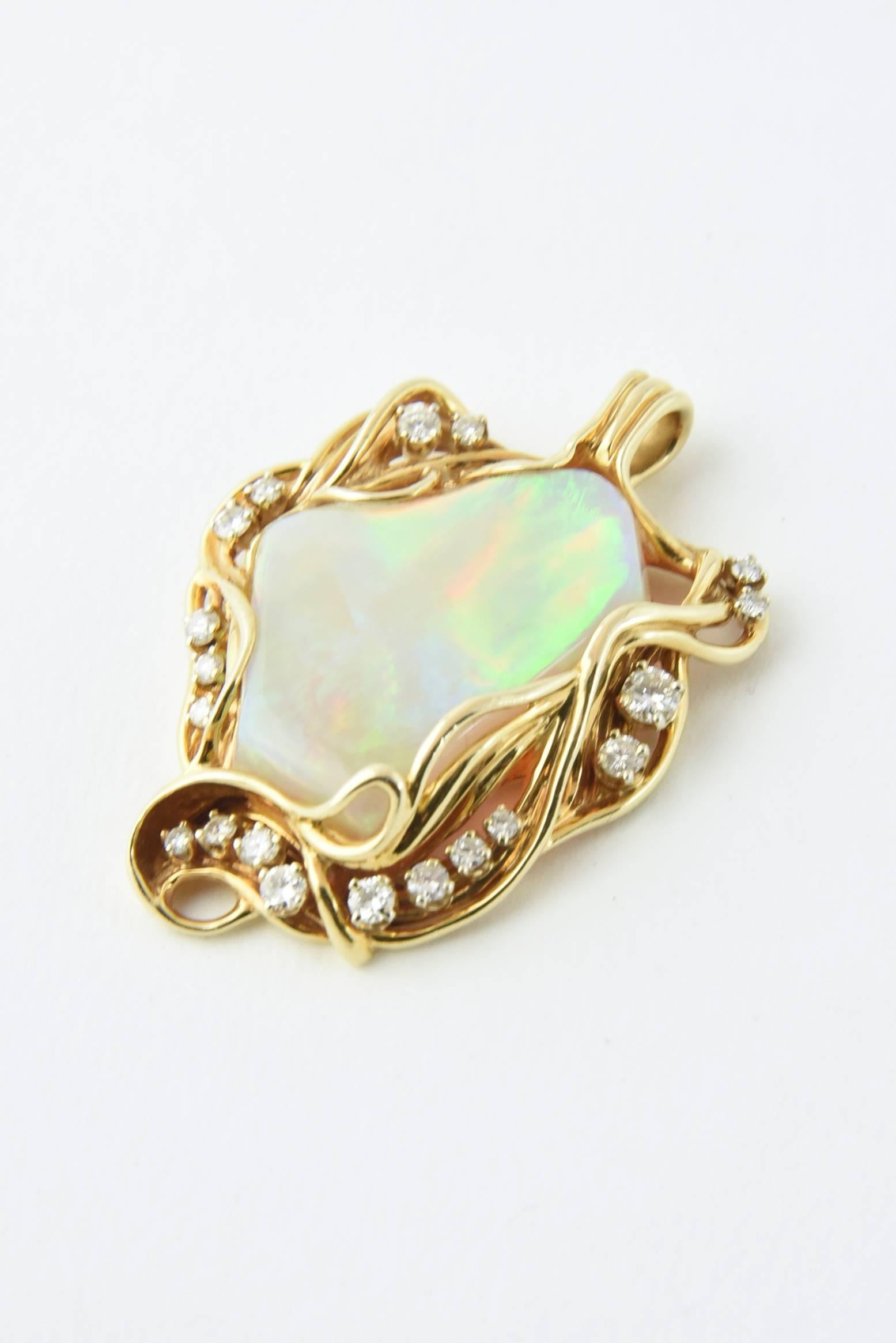 1960s Custom pendant made to showcase this fine quality gray opal which features blue, green, red & yellow broad flashes.  This gorgeous Australian opal in mounted in a handmade 14k gold frame with diamond accents.