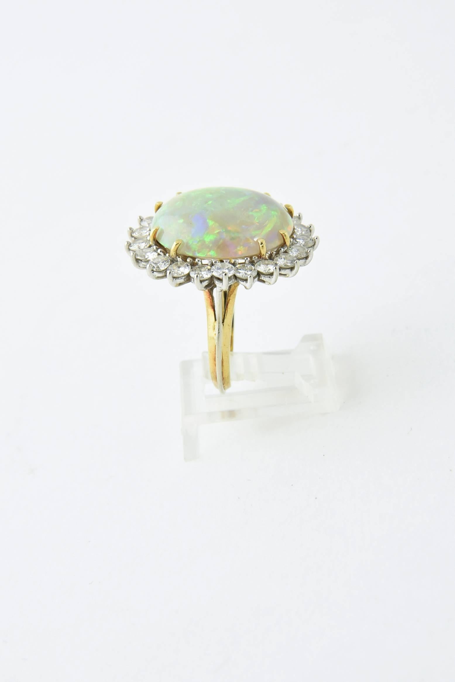 Semi-black Crystal Opal with incredible color with a diamond frame mounted in 18k white & yellow gold.  17.5 carat approximate weight of opal and 2.52c approximate total weight of fine quality diamonds.

US Ring size 6