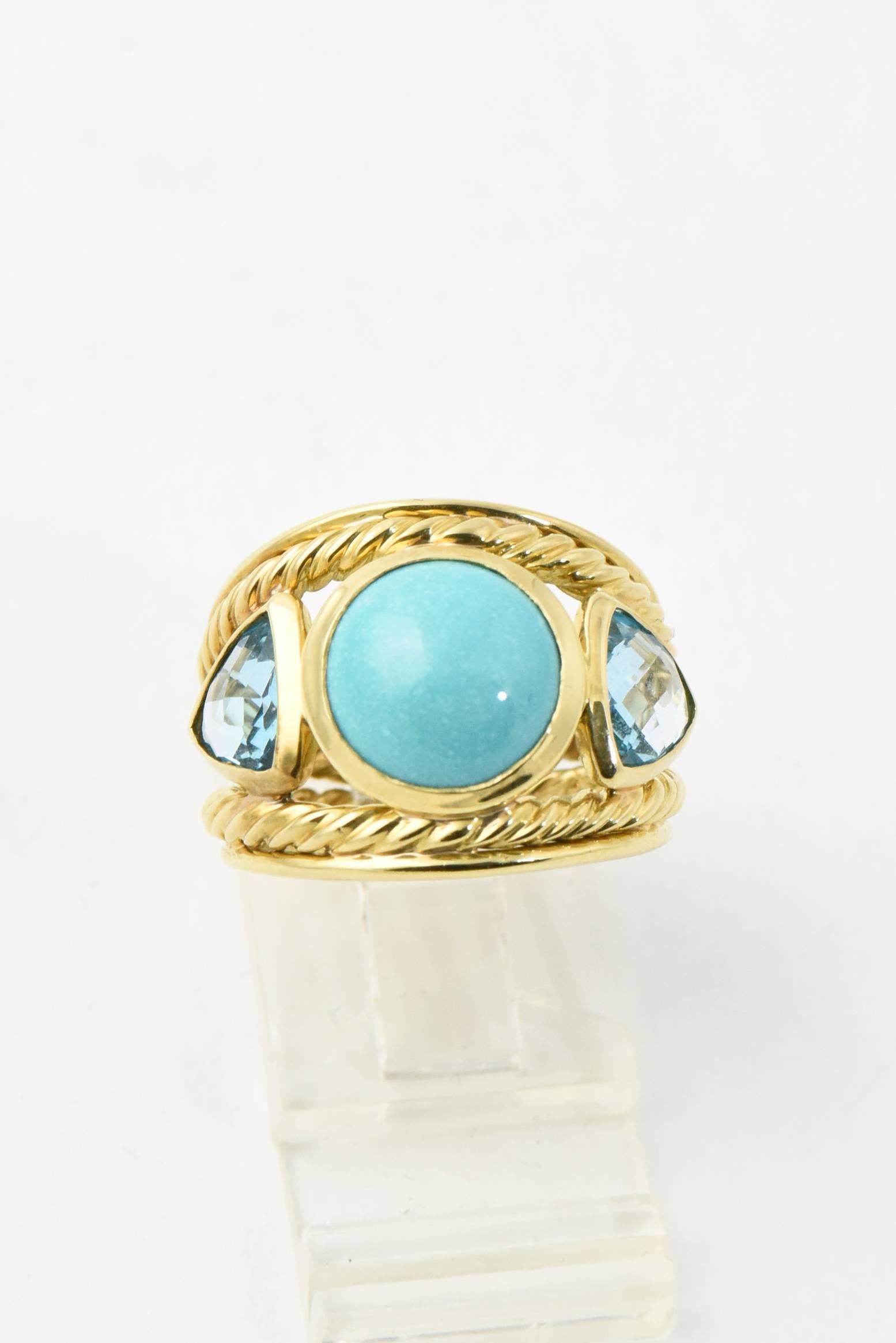 David Yurman 18K yellow gold three stone Renaissance ring with faceted blue topaz side stones and a turquoise cabochon in center. 
Marked 750 & Yurman Hallmark. 
US size: 5.