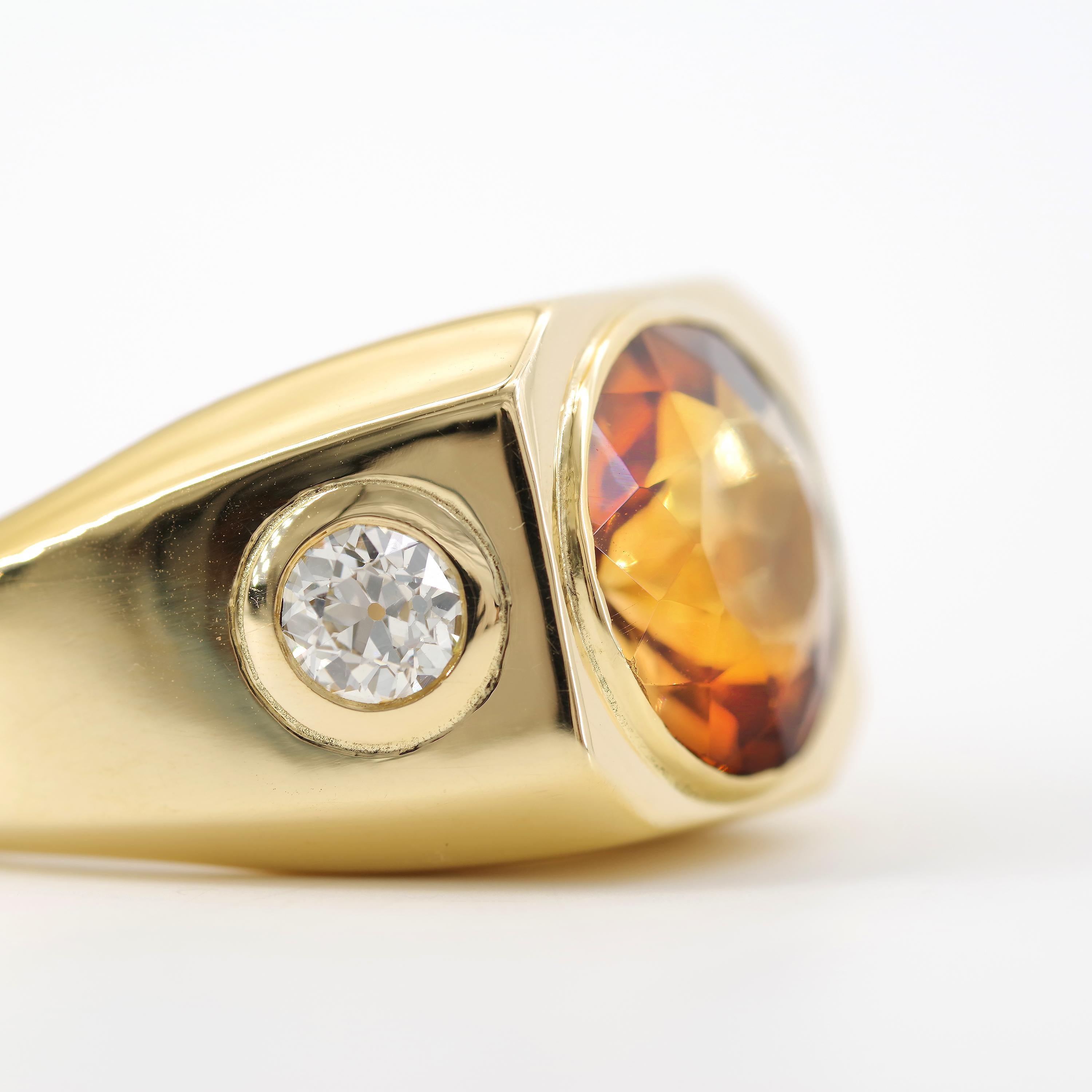 This ruggedly handsome 18k yellow gold ring features a large and round whiskey-colored Brazilian precious topaz that flashes with red, gold and umber, sometimes a little blue. 