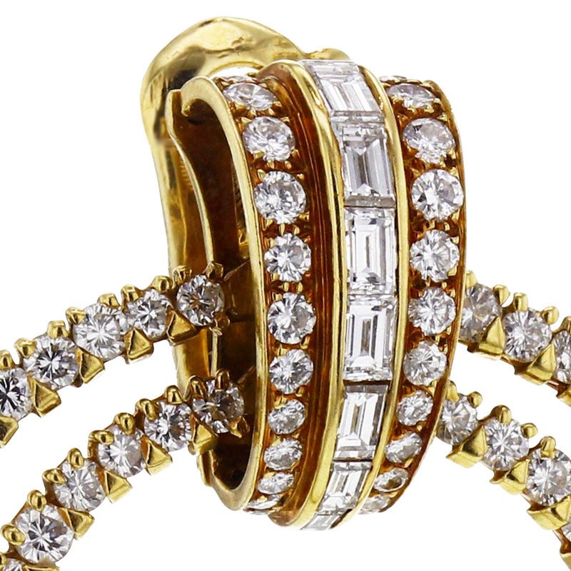 Cartier yellow gold mount double hoop earclips. Set with two lines of round brilliant-cut diamonds and one line of baguette diamonds holding two mobile hoops set with round brilliant-cut diamonds 6 carats total and square-cut diamonds 1.60 carat