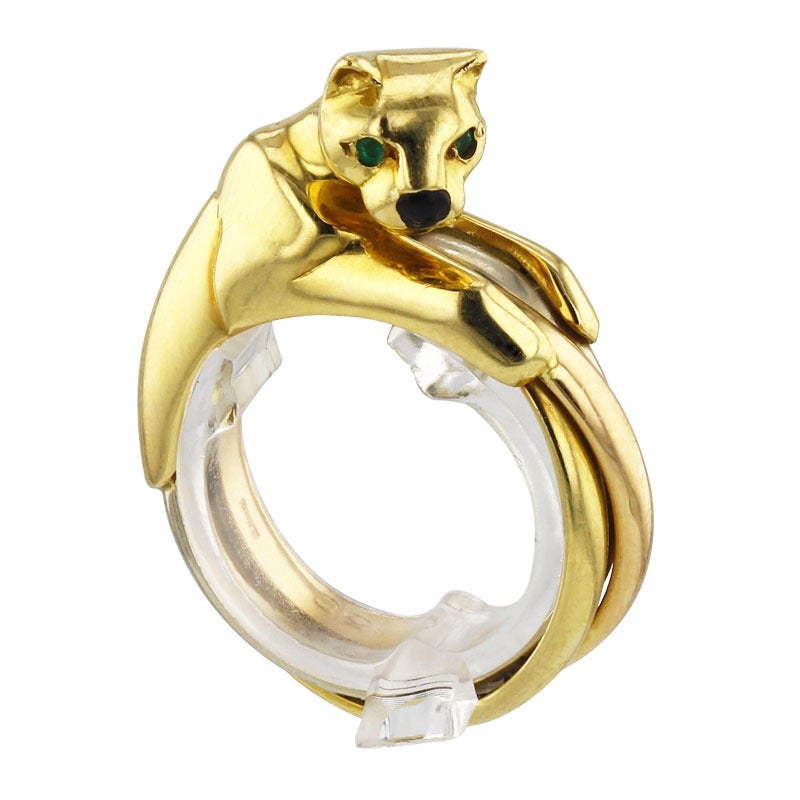 Trinity panther ring by Cartier mount with three kind of gold - yellow, white and rose - and two emerald eyes. Ref. number: 48495950. 
Size US 5 1/4, European 50
