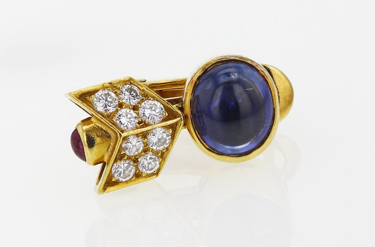 Bulgari arrow design earrings in yellow gold with two cabochon blue oval sapphire, brilliant-cut white diamonds and two cabochon ruby. Signed Bulgari, circa 1990s.