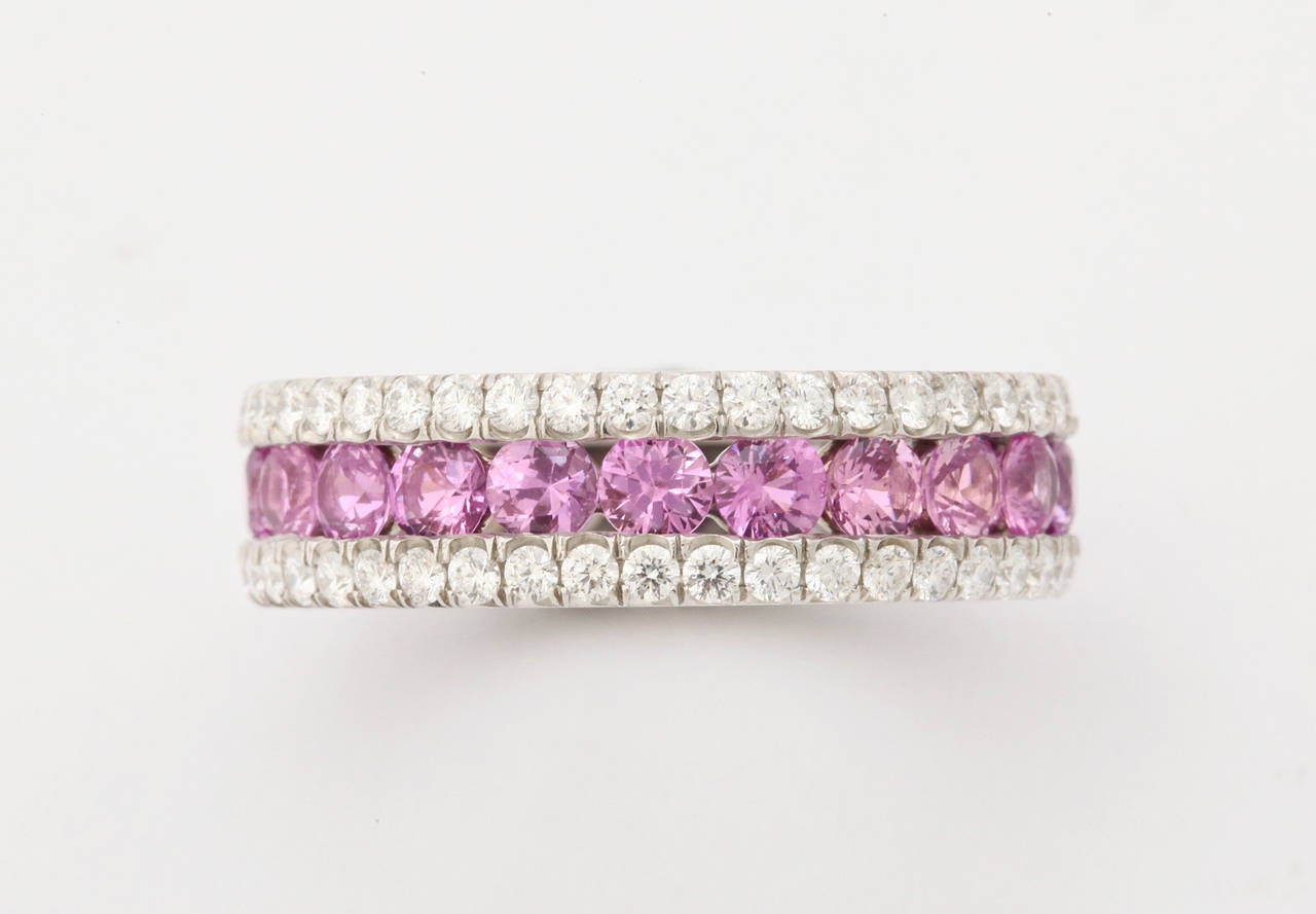 Very finely made platinum,pink sapphire (app. 3cts) and round diamond (app. 1ct) eternity band ring. Presently size 6 1/2. The ring can be adjusted to fit from size 5 to 7.

From a family of jewelers dating back to 1927, Michael Kanners is