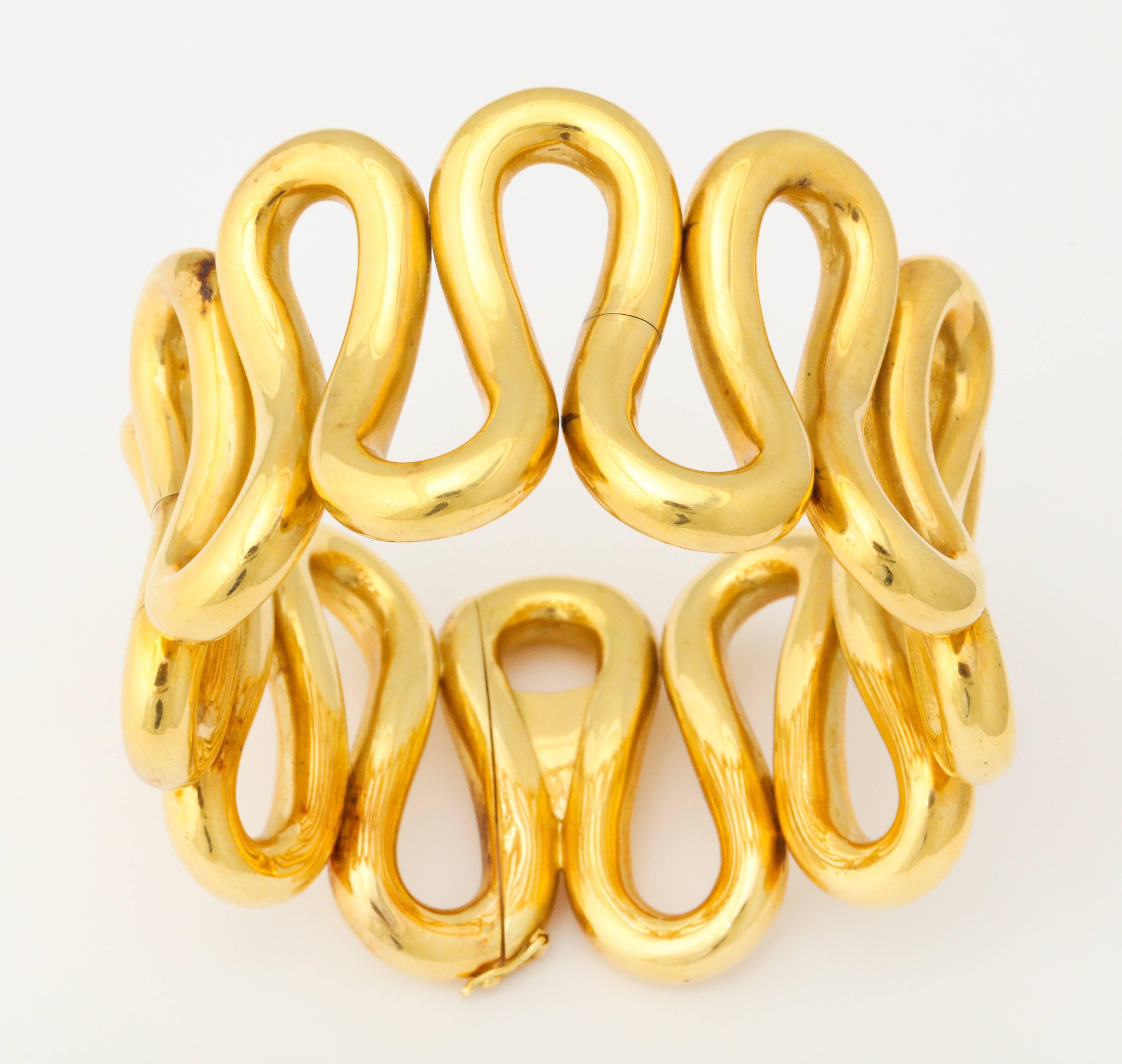 A bold and chic 18kt yellow gold wave design bracelet, as only the Italians know how to do it.  The overall width is 1 1/2 inches and the bracelet will comfortably fit a wrist size of up to 7 inches.  Weighing in at just over 4oz, you will know that