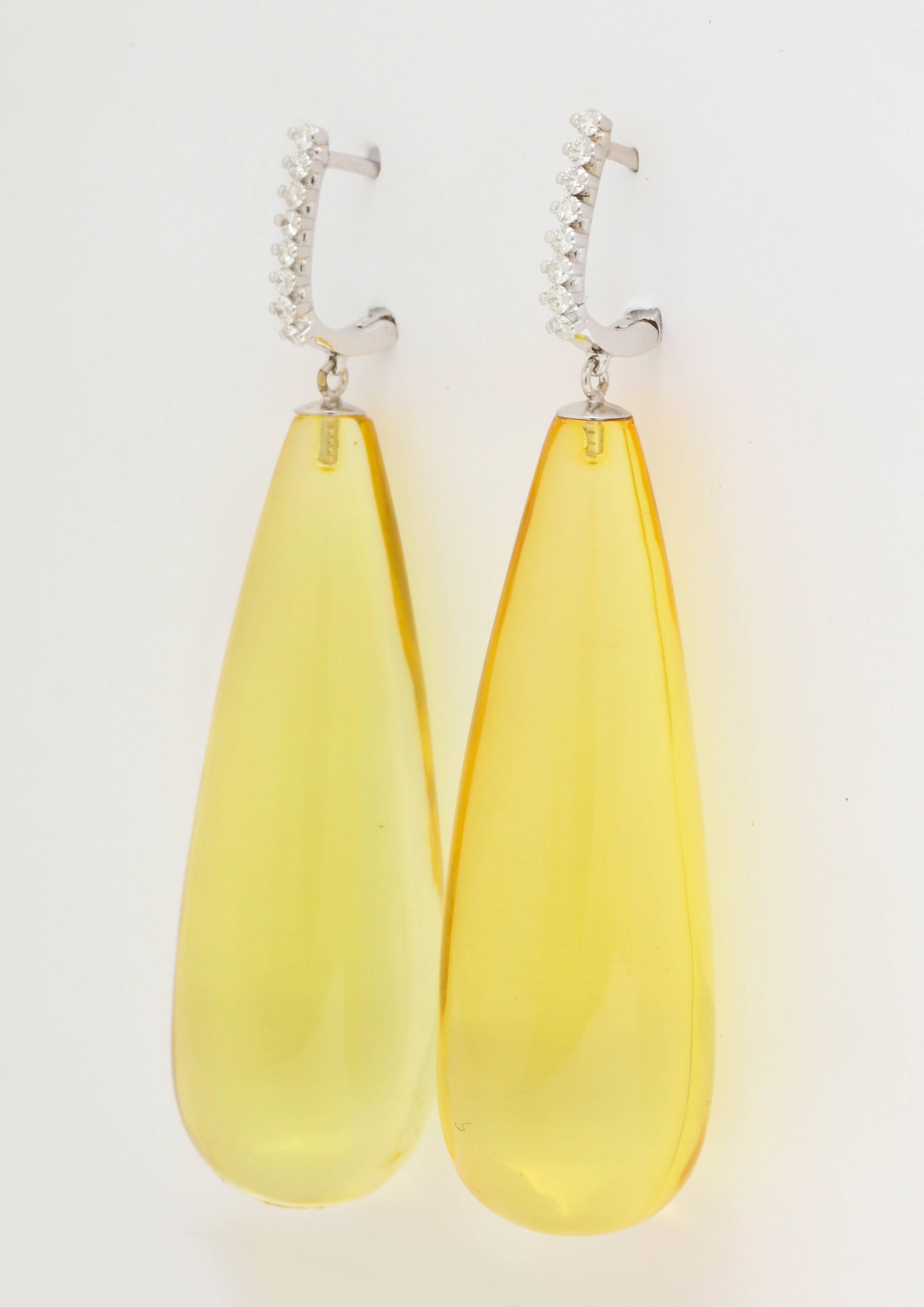 Weighing in at a feather light 1/2  ounce, these 2 1/2 inch long earrings are sure to impress, while being an absolute pleasure to wear.  The bright, lemon yellow amber drops are like bursts of sunshine, and the diamond tops add just the right touch