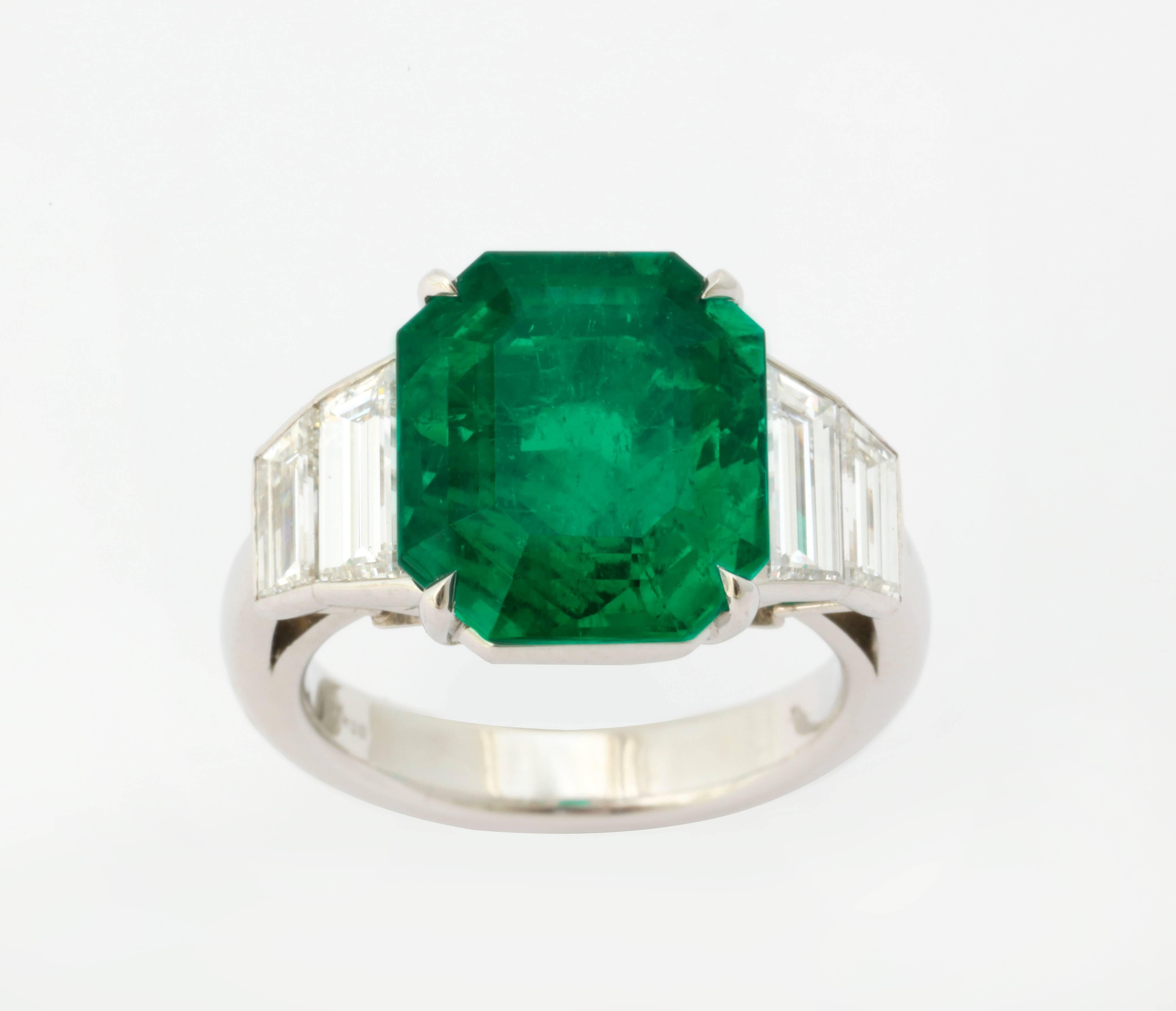 The 6 1/2 carat emerald (6.52cts) is a very elegant cut cornered emerald cut shape.  In a colored stone, this is shape is highly sought after, and rarely found- similar to asscher cut diamonds.  The very fine stone is boldly mounted in platinum with