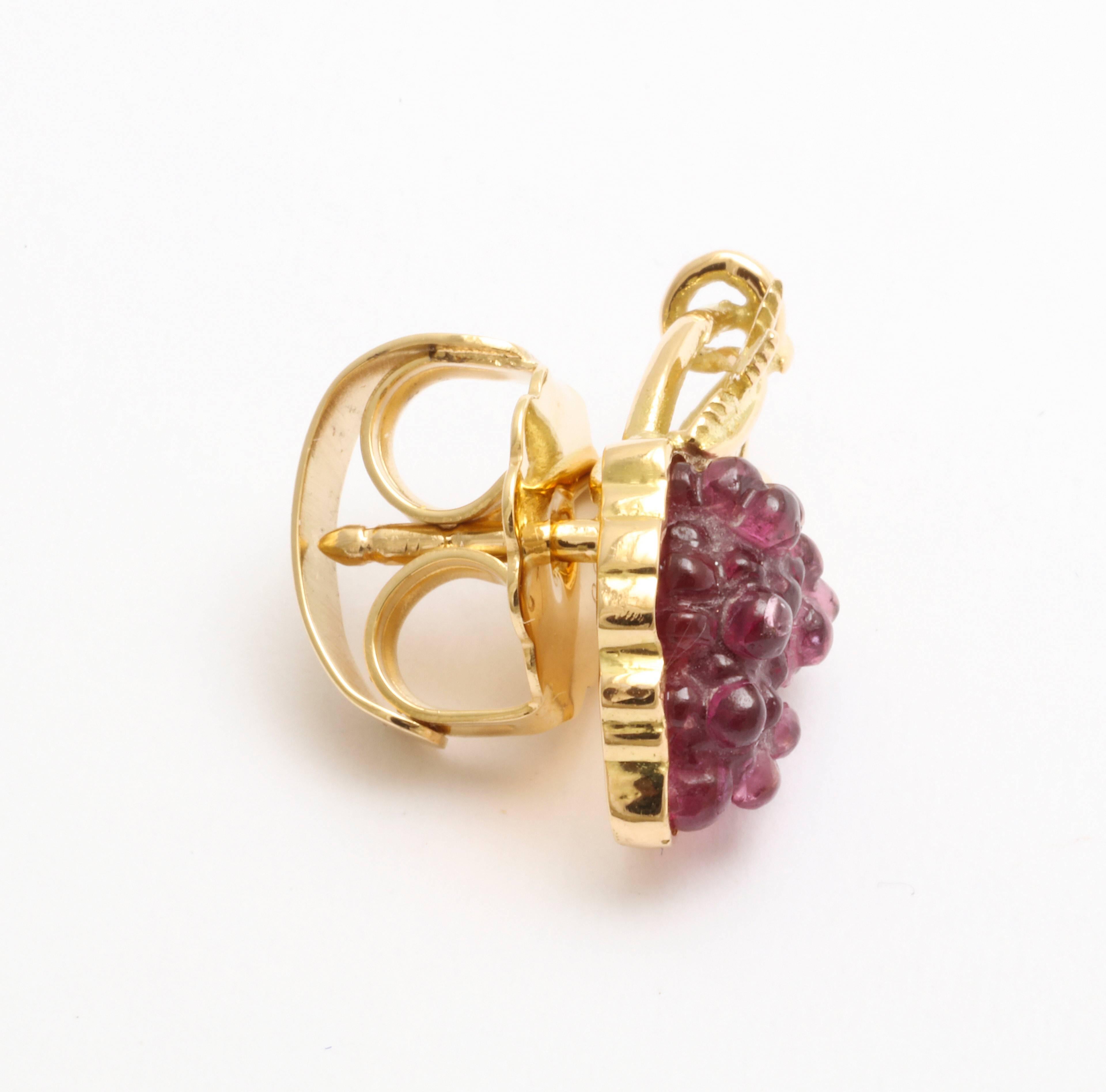 For the wine lover, this cluster of grapes is realistically recreated in 18kt yellow gold and carved pink tourmaline.  

